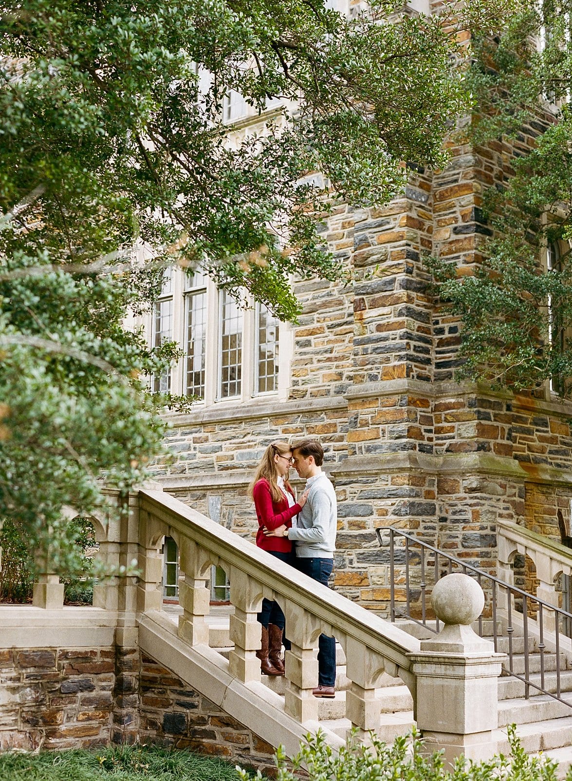 Durham, NC engagement session on Duke campus couple standing on stone stairwell outside photo