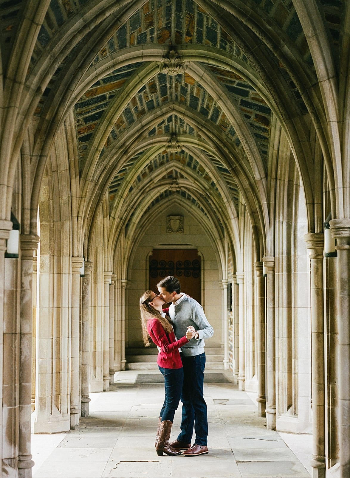 Duke engagement session couple under the duke chapel arches photo