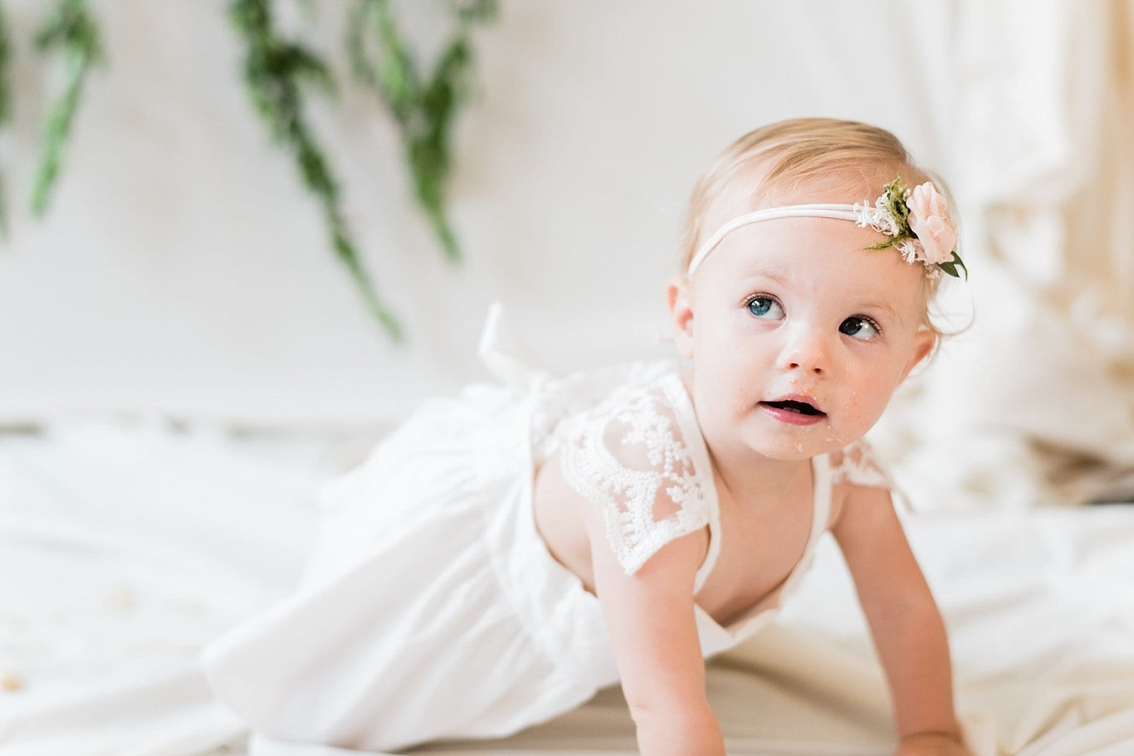Raleigh 1 year old in an ivory dress with lace criss cross straps photo