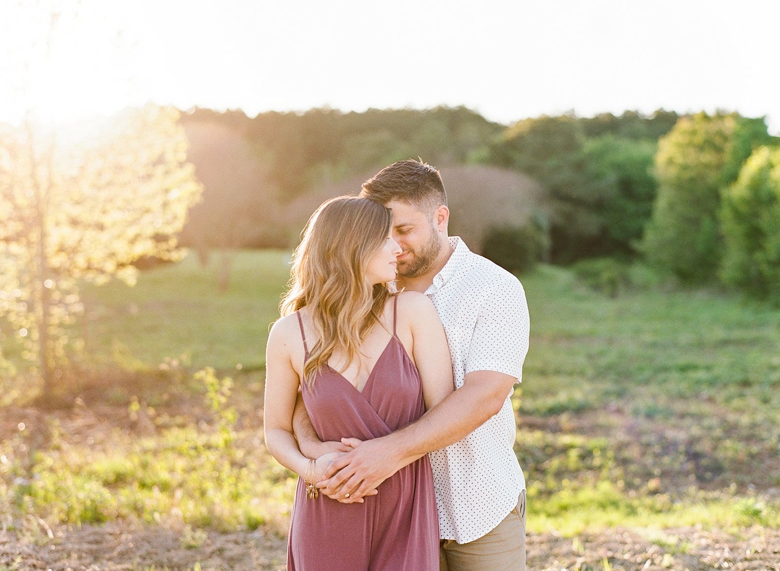 Raleigh couple embracing during sunset engagement photo