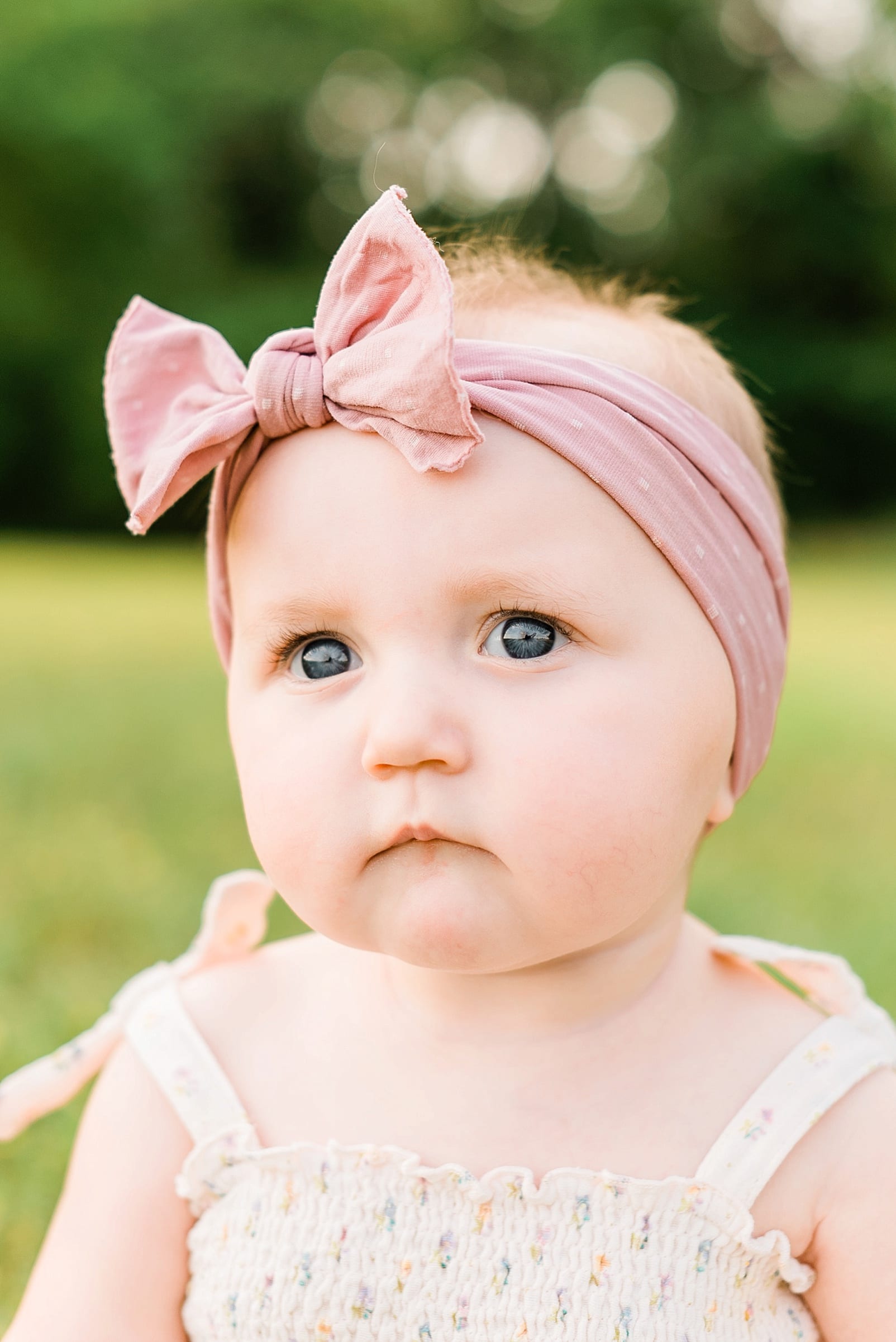 Wake Forest 9 month old with a blush pink bow headband up close photo