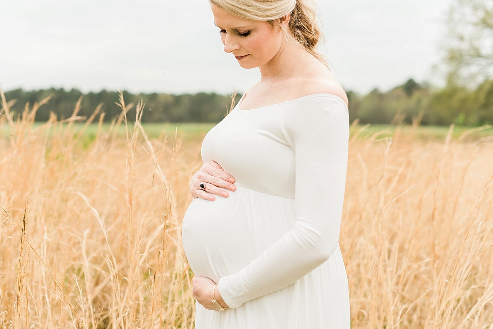 Raleigh Maternity session mother in off the shoulder off-white long sleeved dress photo
