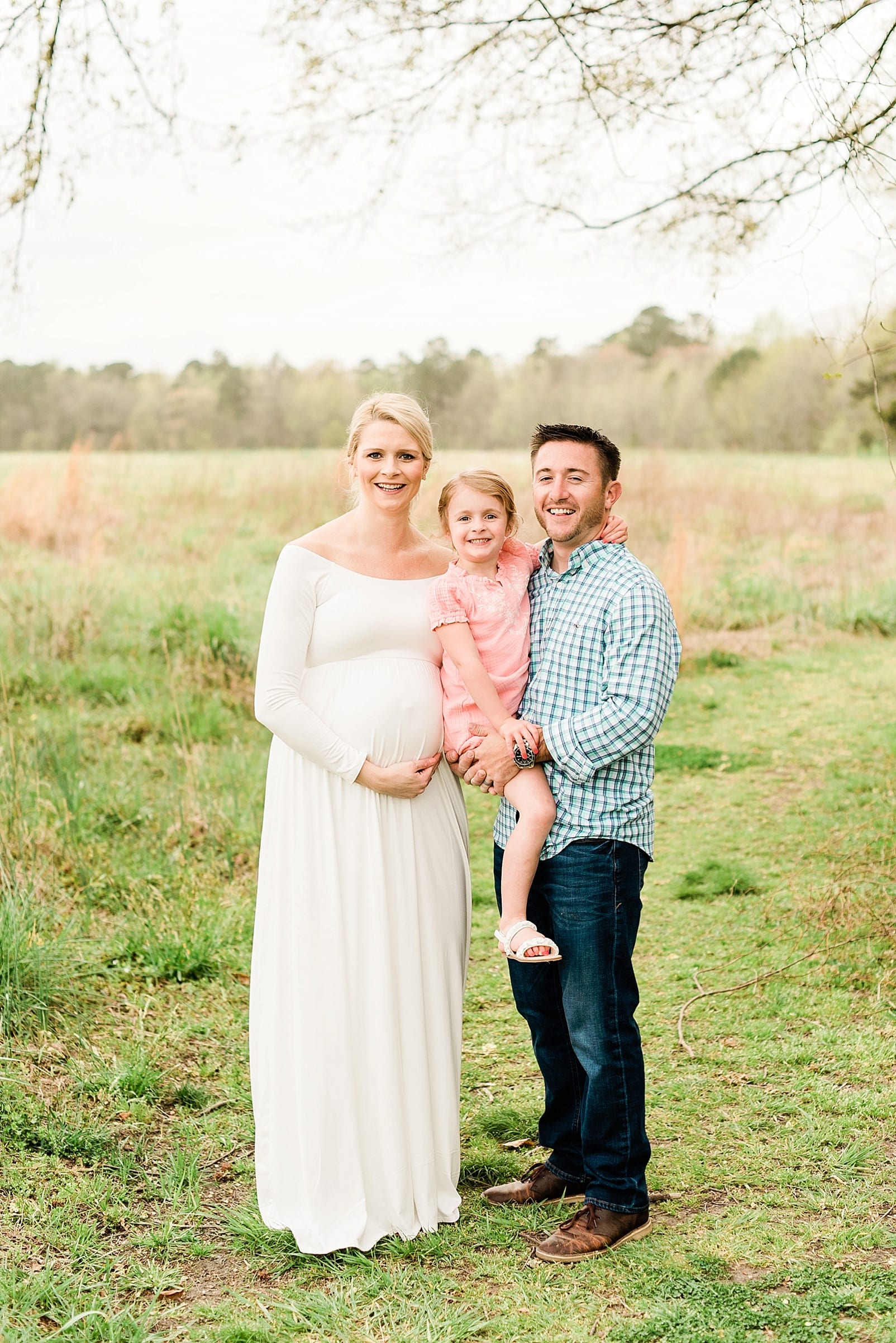 Wake Forest family holding their four year old daughter during maternity session photo