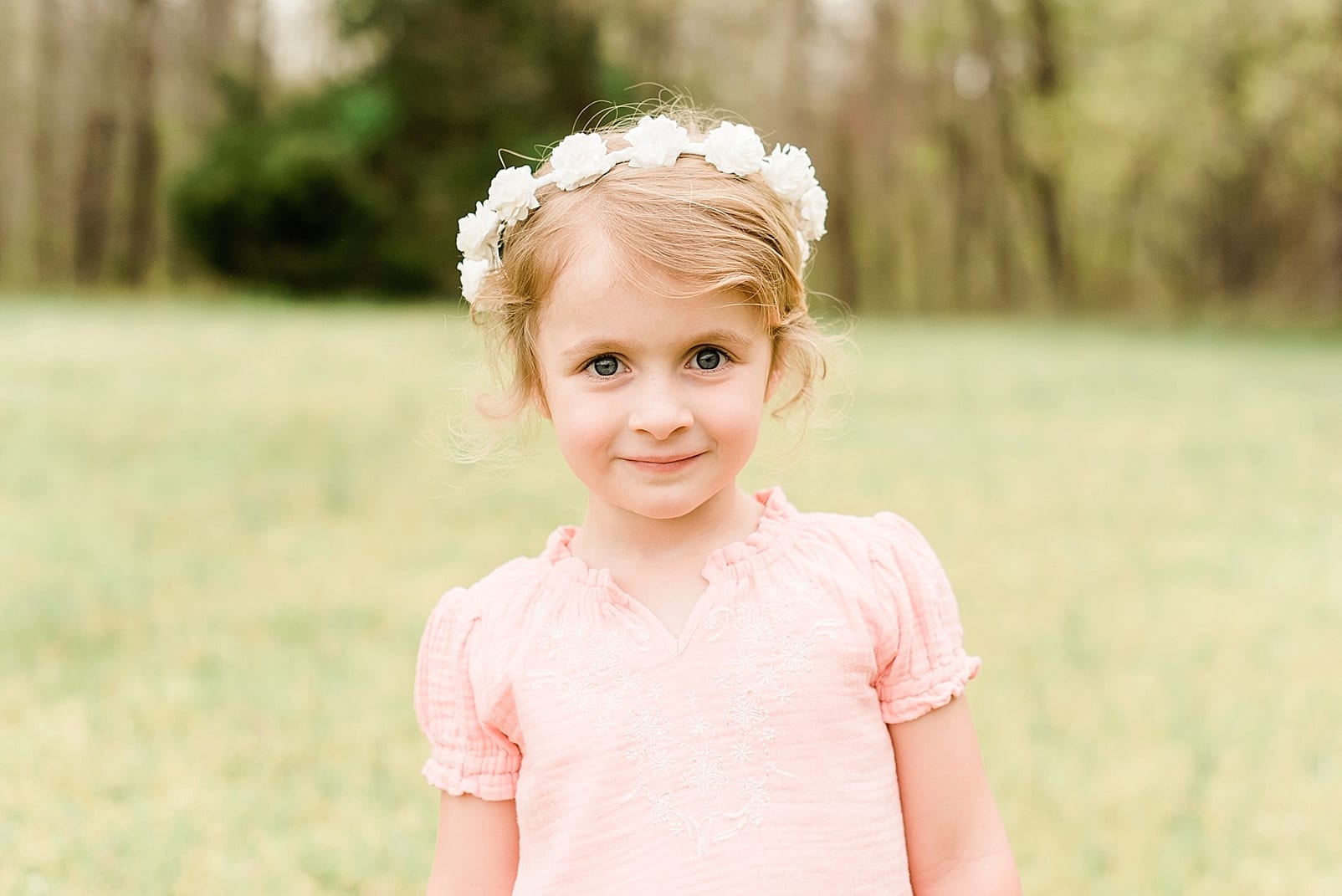 Wake Forest four year old girl in a light pink dress wearing a white flower crown photo