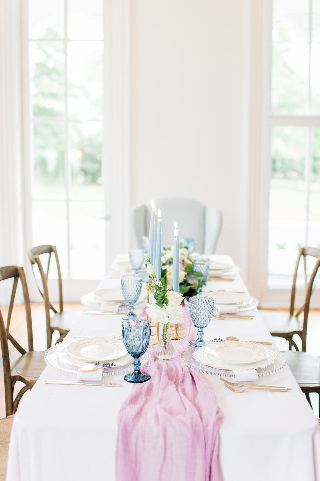 Greenhouse Picker Sisters wedding inspiration table setting with light pink table runner, light blue goblets, and light blue taper candles in gold candle holders photo