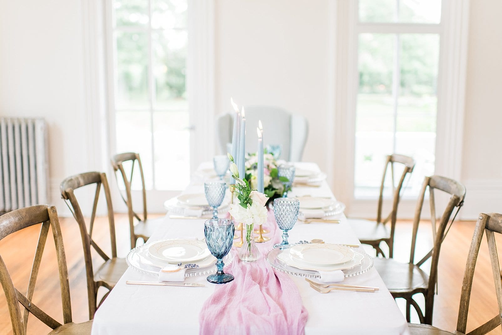 Greenhouse picker sisters specialty rentals table place setting with pink table runner and light blue accents photo