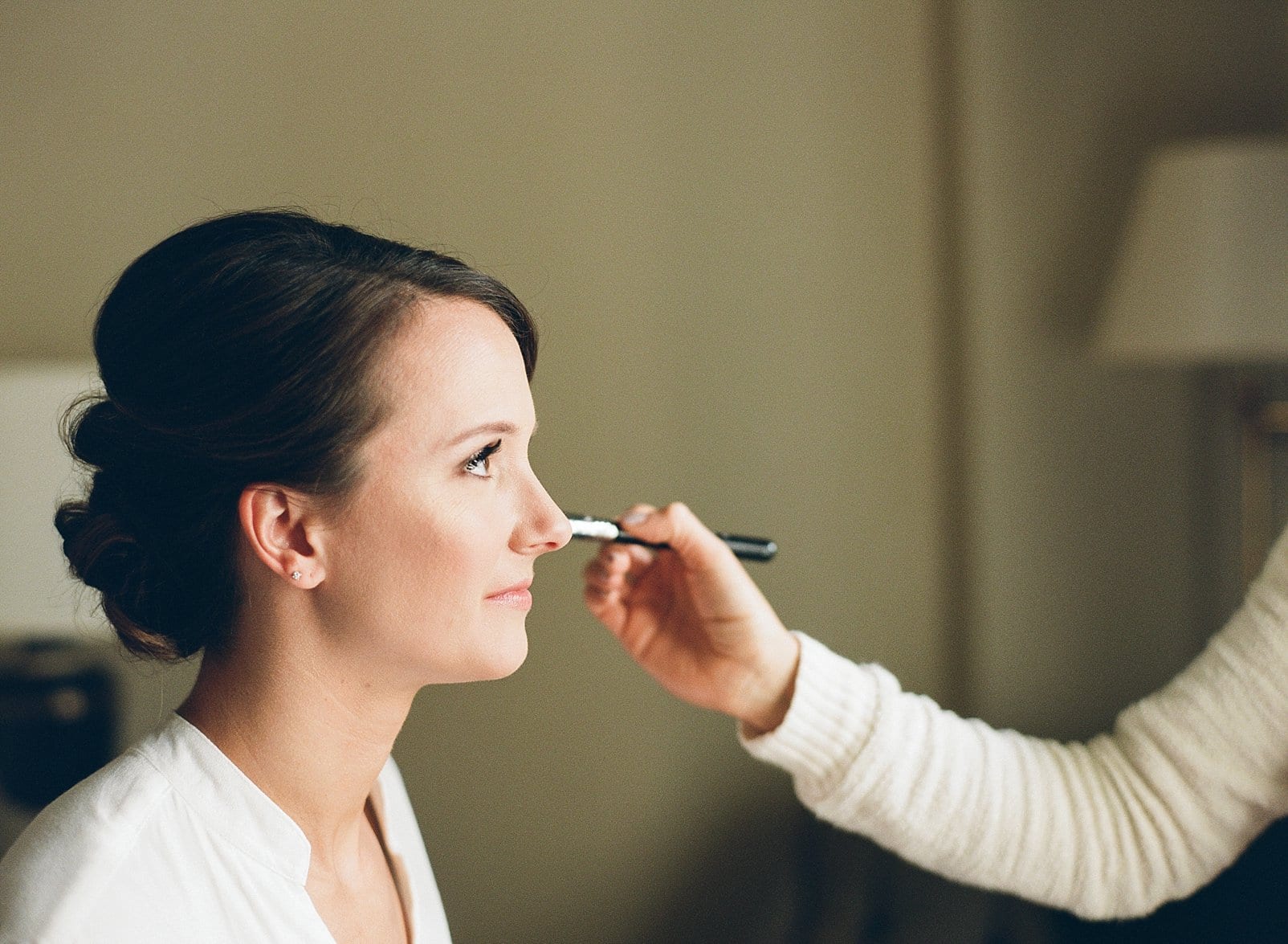 Tease & Brush finishing the bride's makeup photo
