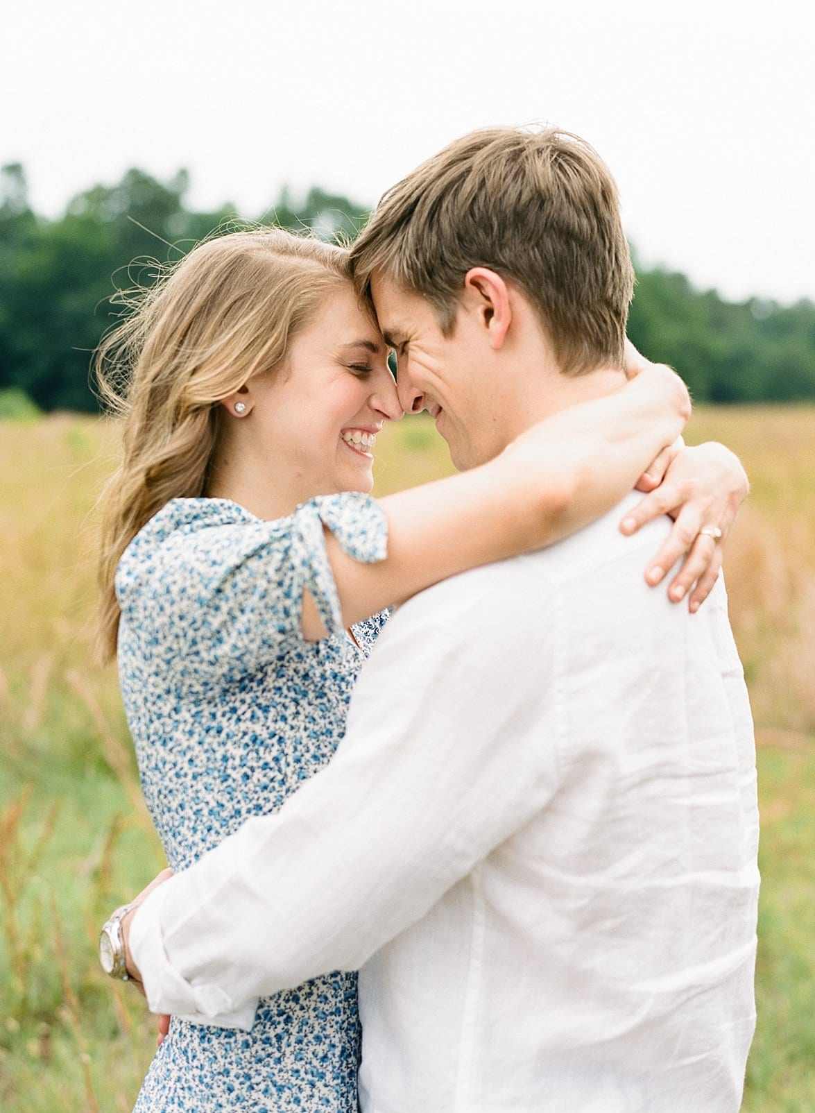 Film photography in Raleigh engaged couple with her arms around his neck photo