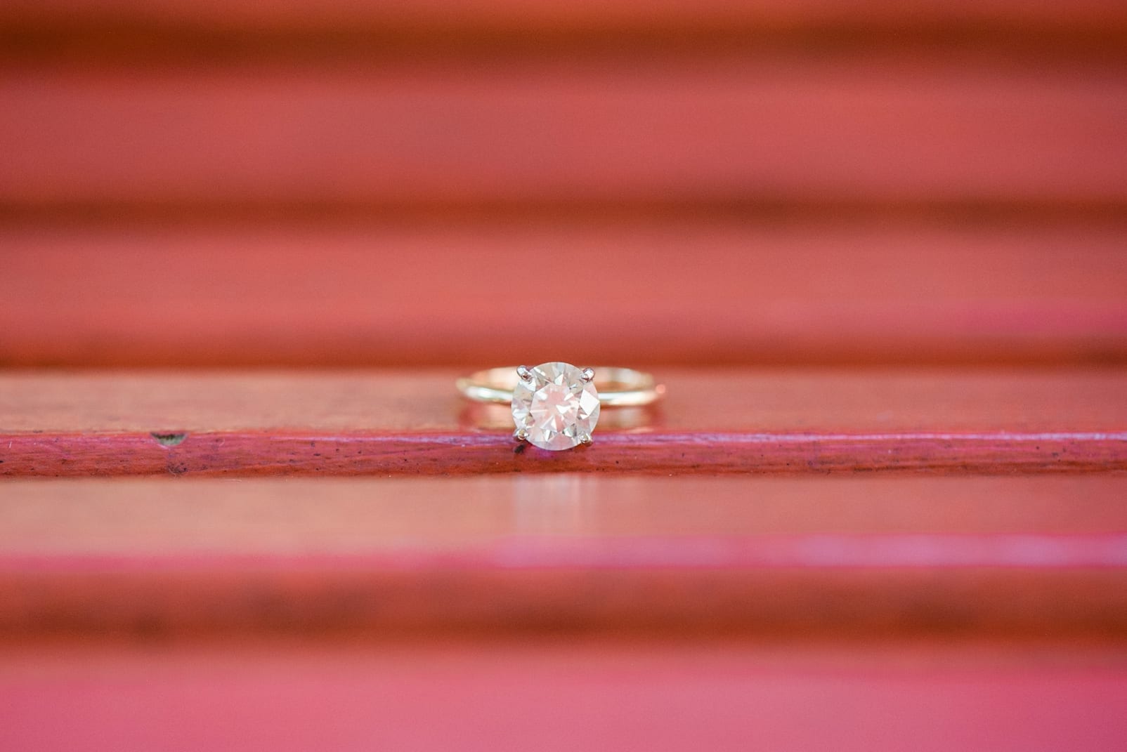 Raleigh engagement ring on red porch swing photo