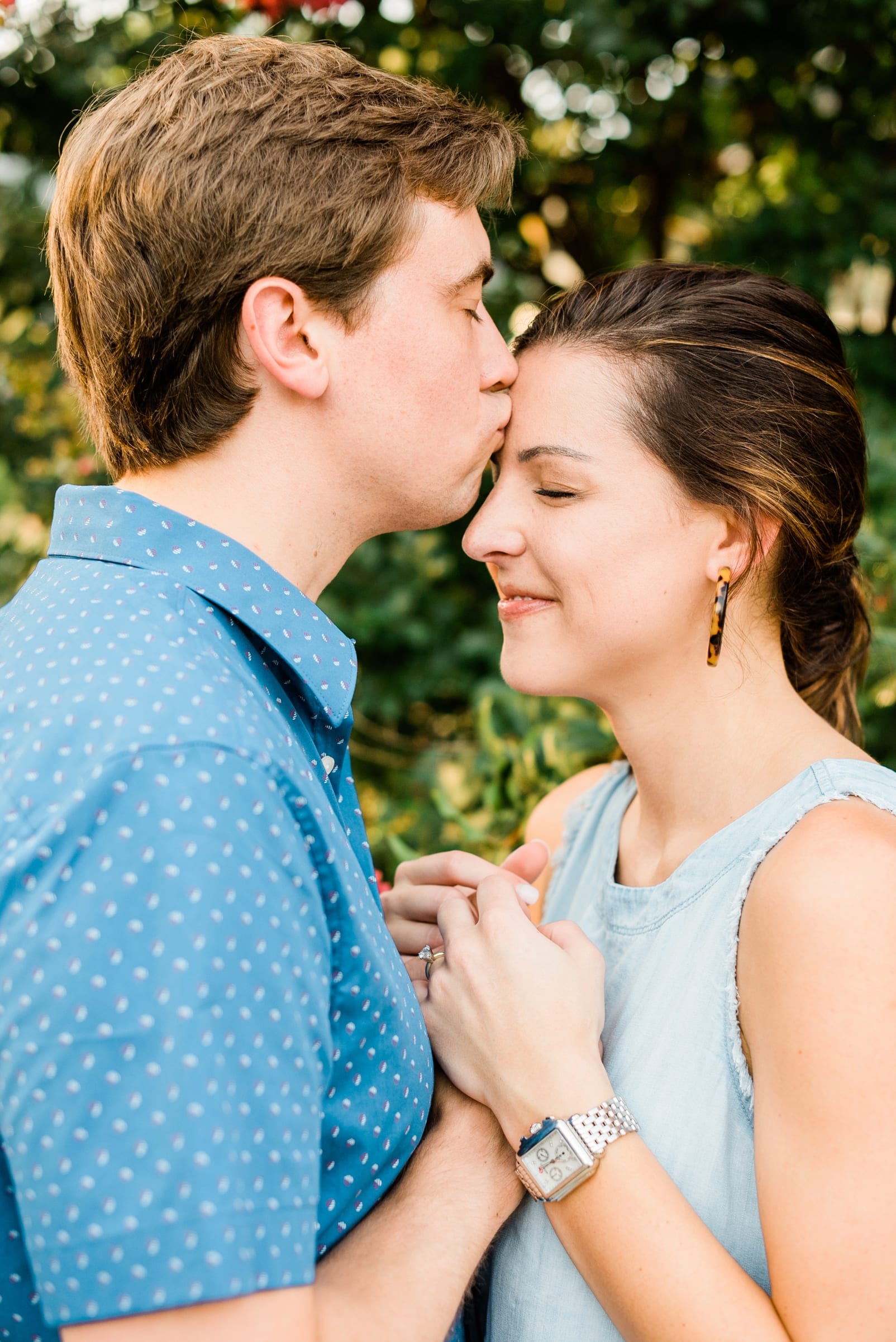 Raleigh engagement session groom kissing his bride on her forehead photo
