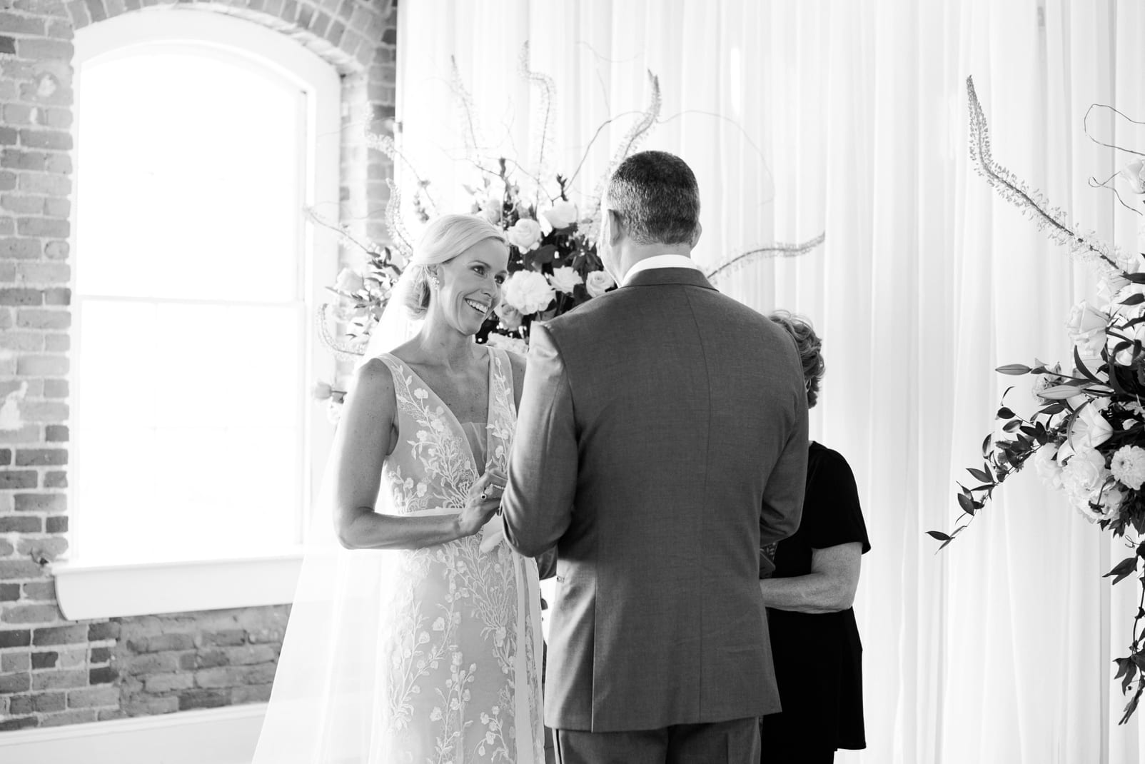 Raleigh wedding ceremony with bride crying while looking at her groom photo
