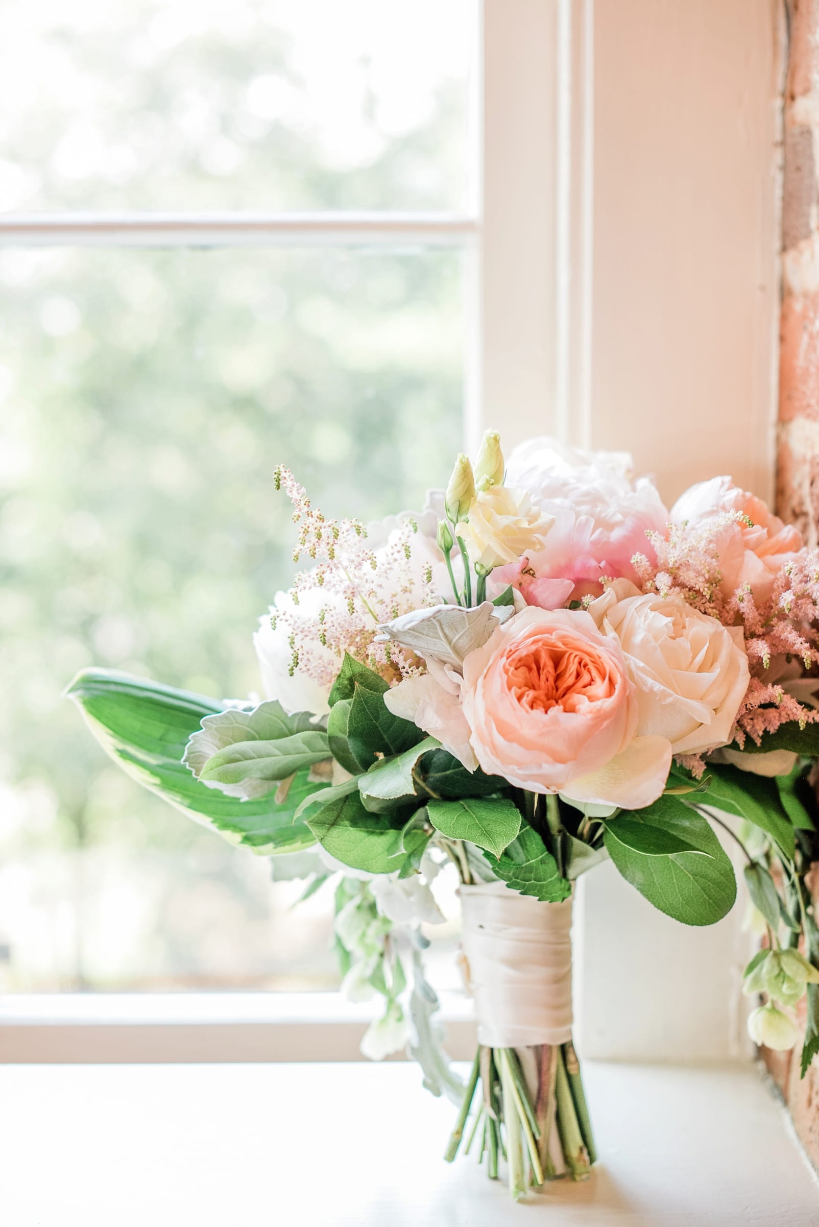 Kelly Odom Flowers bridal bouquet with greenery with peach flowers photo