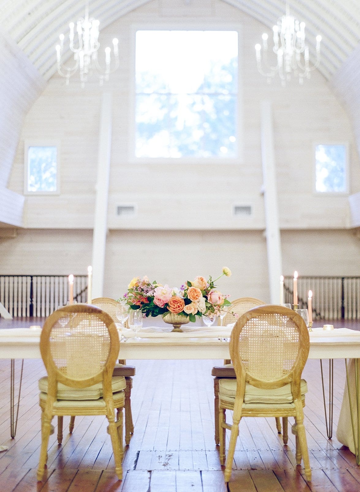 Historic Wakefield Barn indoor wedding reception sweetheart table with gold armed chairs photo