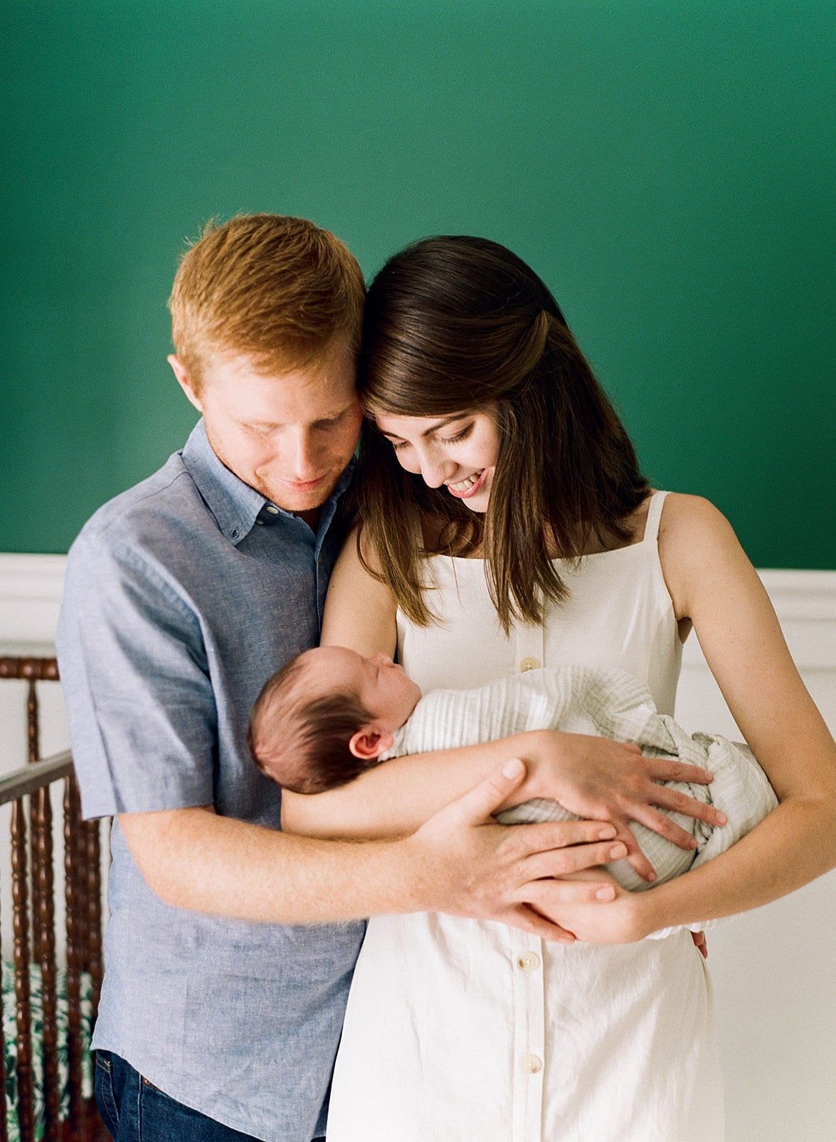 nc film newborn session with mother and father holding their newborn son photo