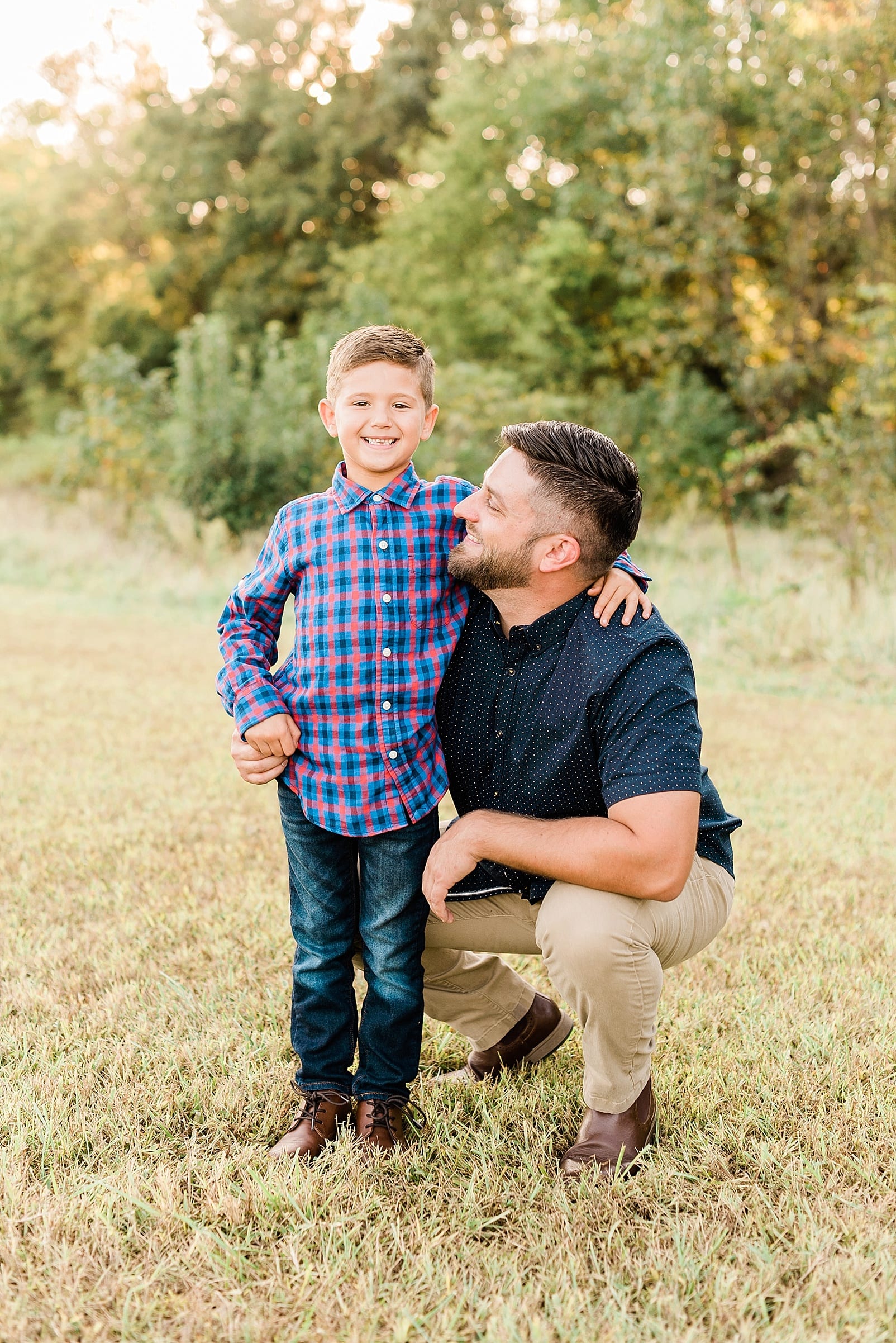 Raleigh boy and his stepfather crouched down with him photo.