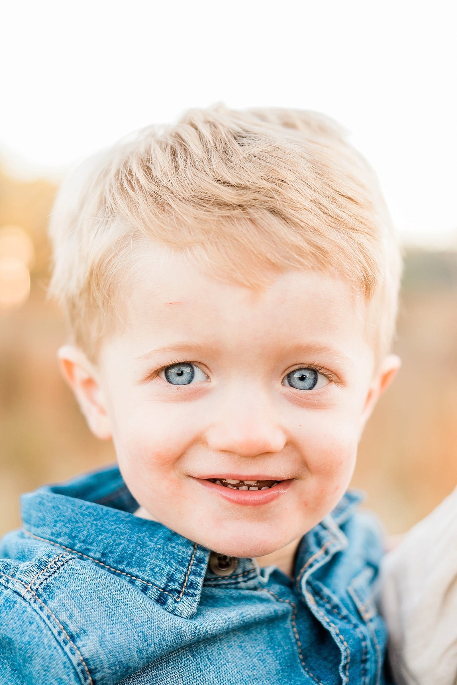 Raleigh close up of a two year old boy with bright blue eyes photo
