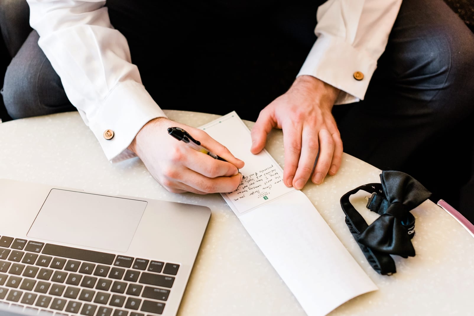 Raleigh groom writing down his letter to his bride photo