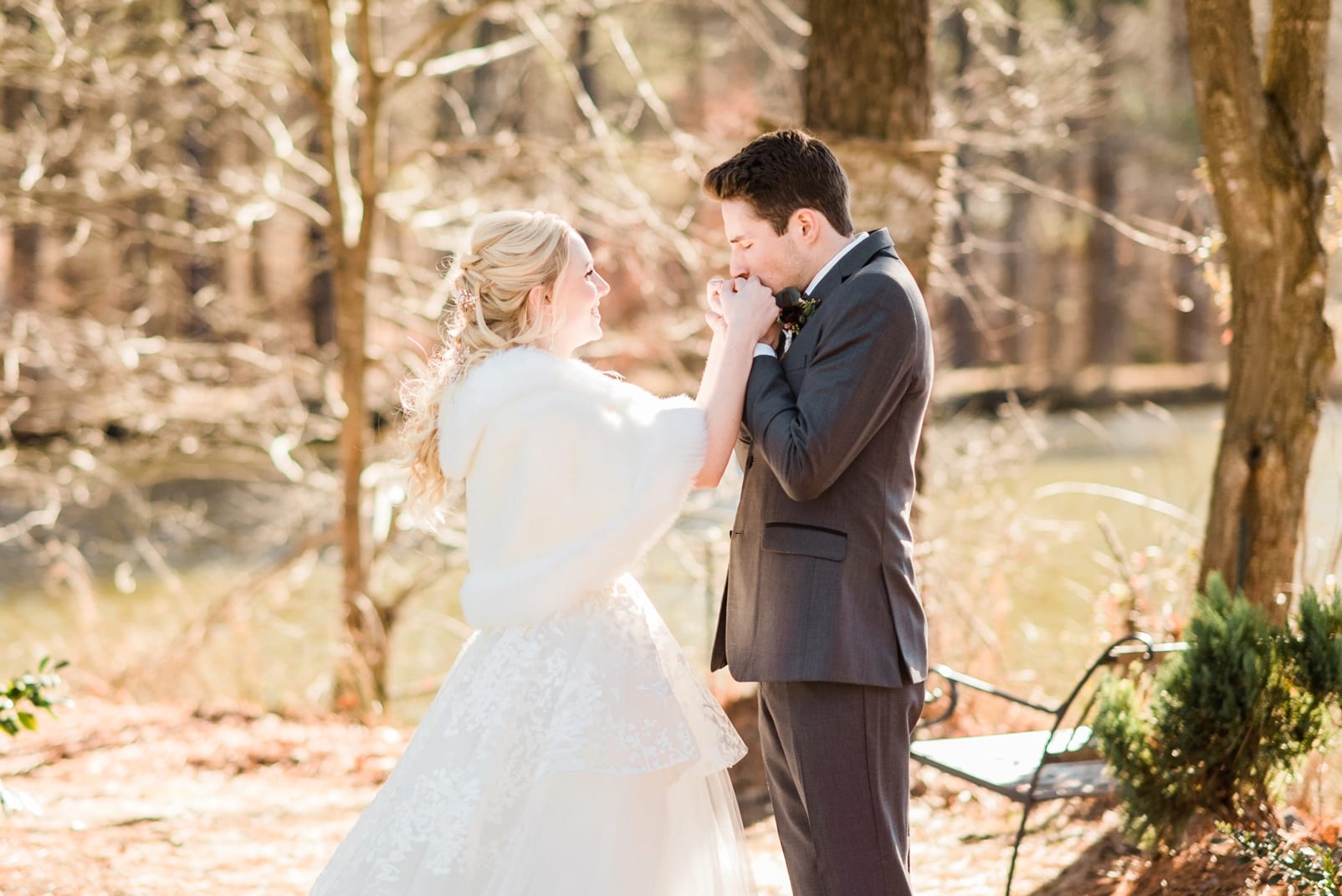 Angus Barn groom kissing his bride's hands after their first look photo