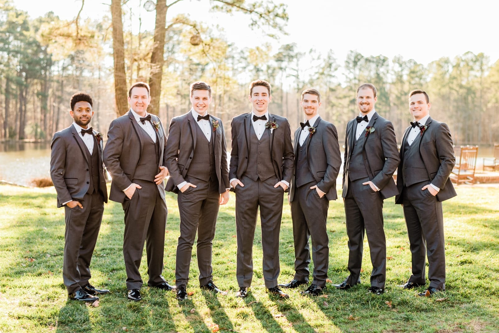 Angus Barn groomsmen wearing black tuxedos with their hands in their pockets photo