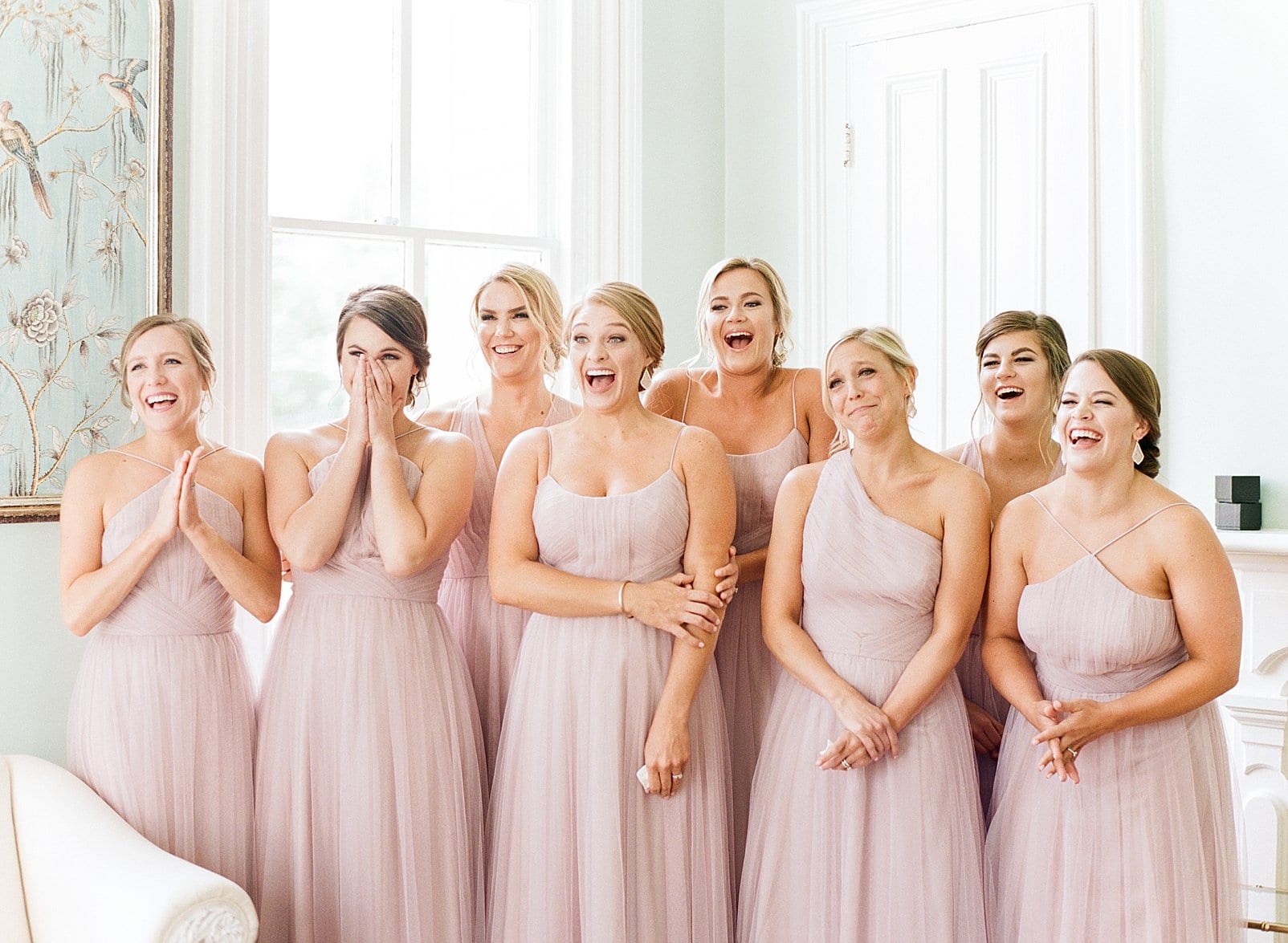 Merrimon Wynne bridesmaids in long light pink gowns seeing the bride dressed for the first time photo