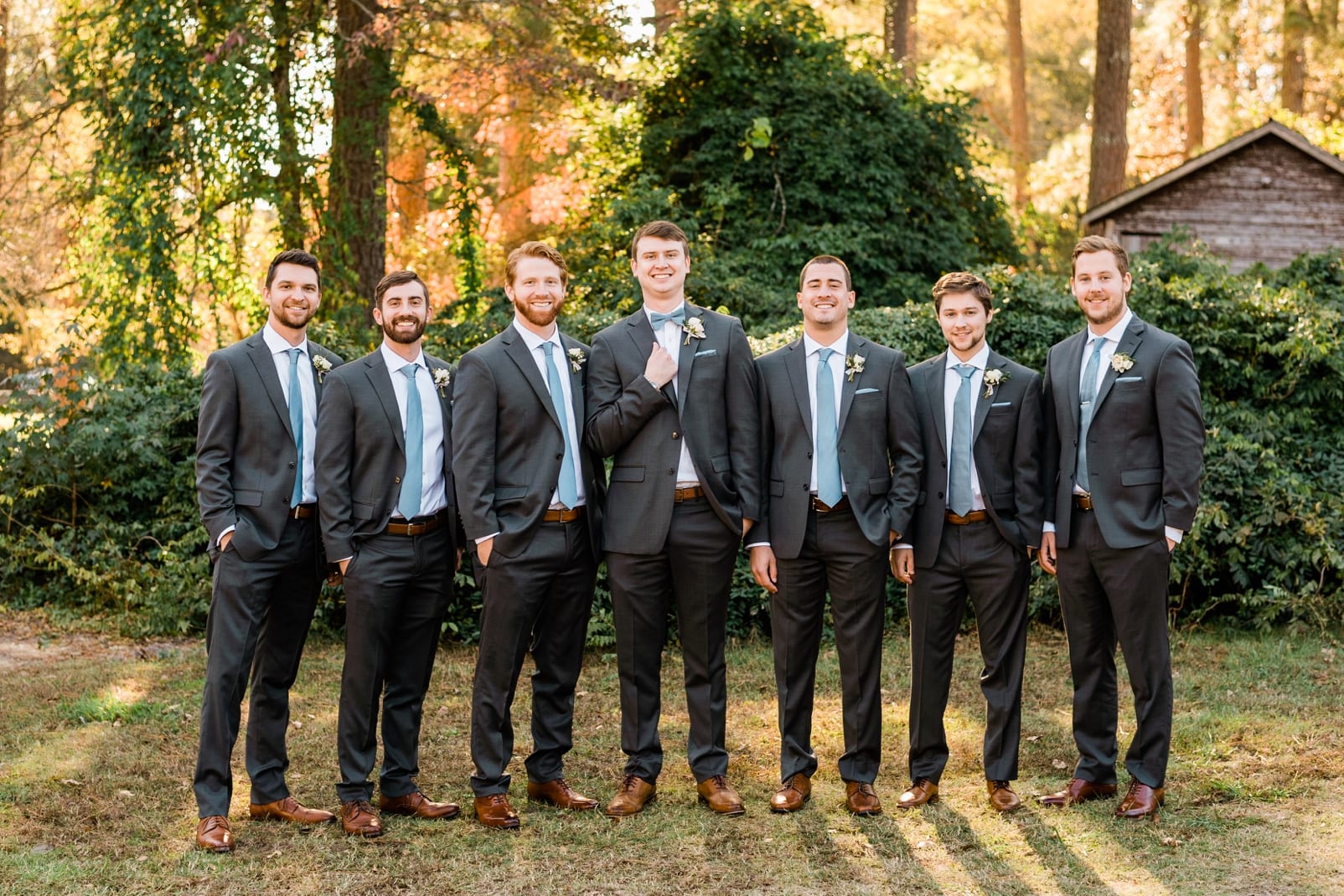 Oaks at Salem groom with his groomsmen in gray suits with dusty blue ties photo