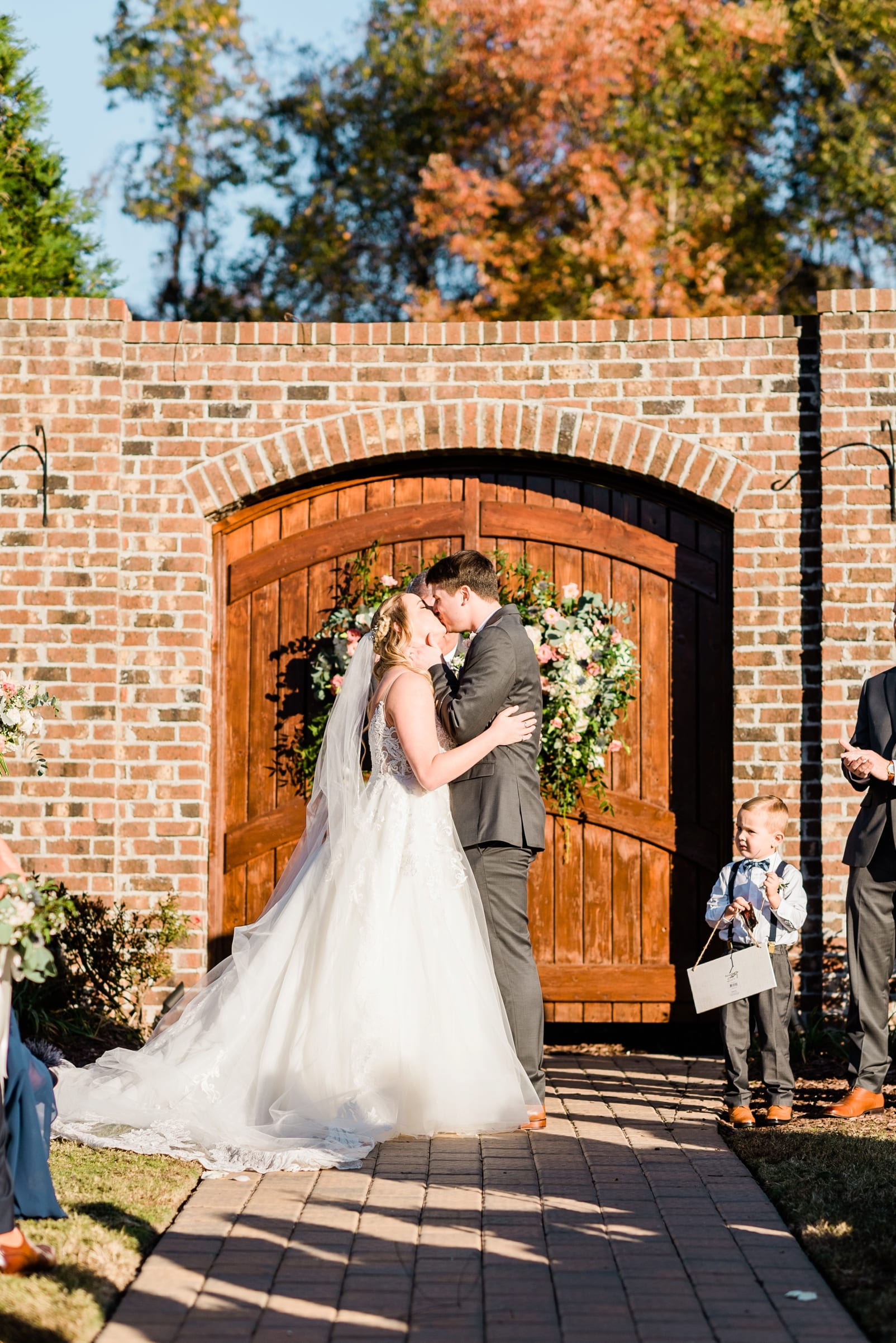 Oaks at Salem bride and groom first kiss after getting married photo