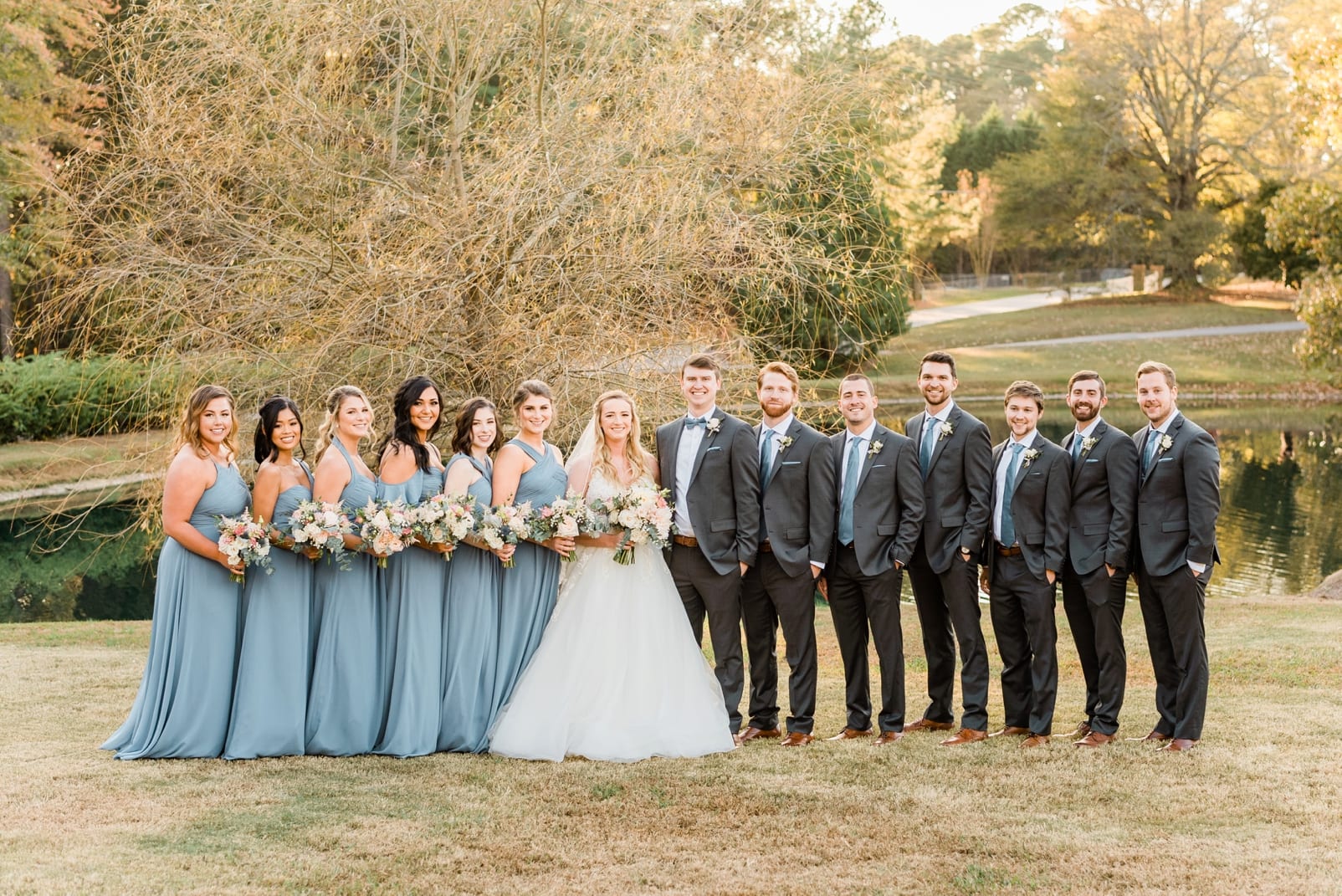 Raleigh wedding party in gray suits and long blue dresses with the bride and groom photo