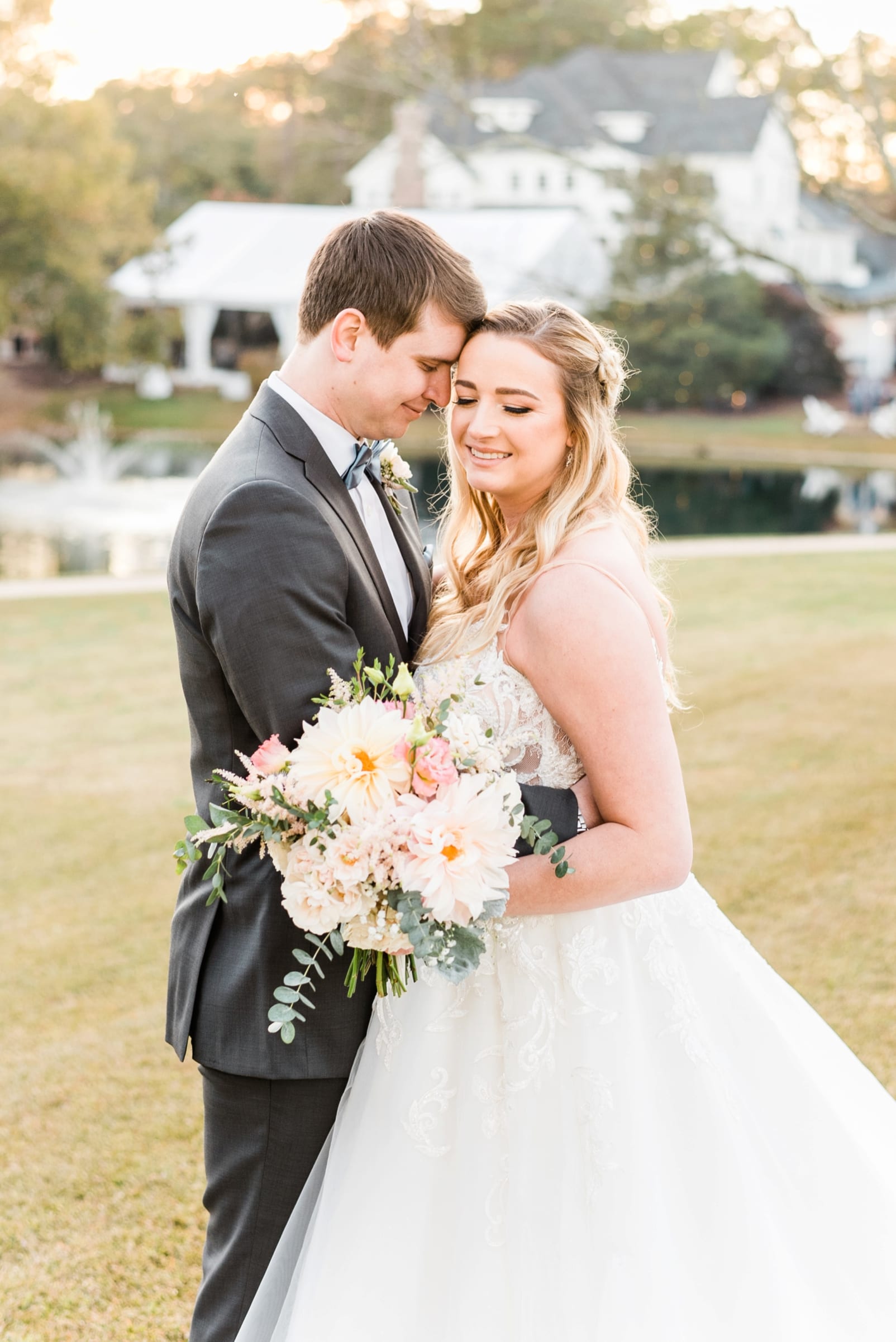 Raleigh groom looking at his bride while they stand together in front of the Oaks at Salem photo