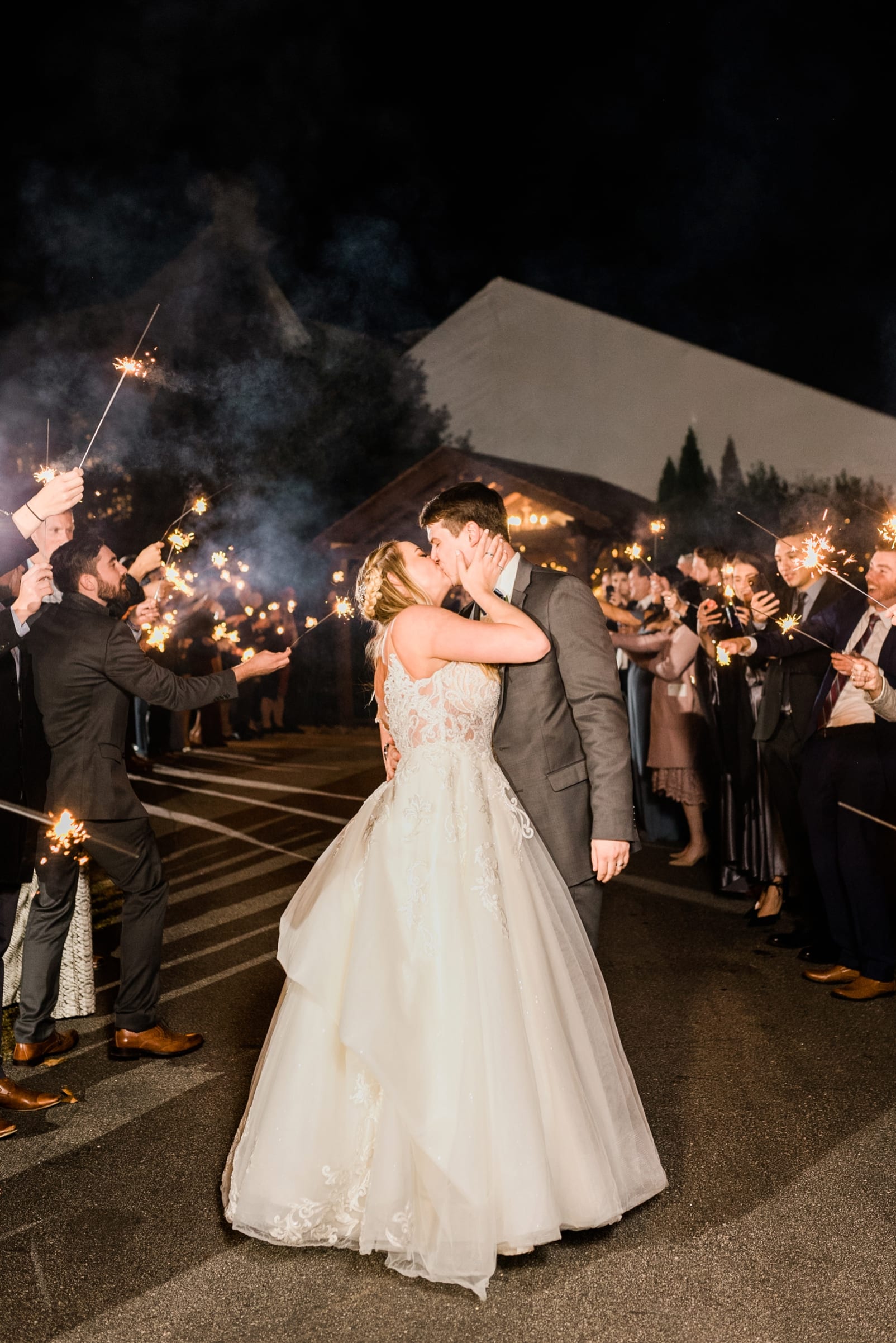Oaks at Salem bride and groom kissing after a sparkler exit photo
