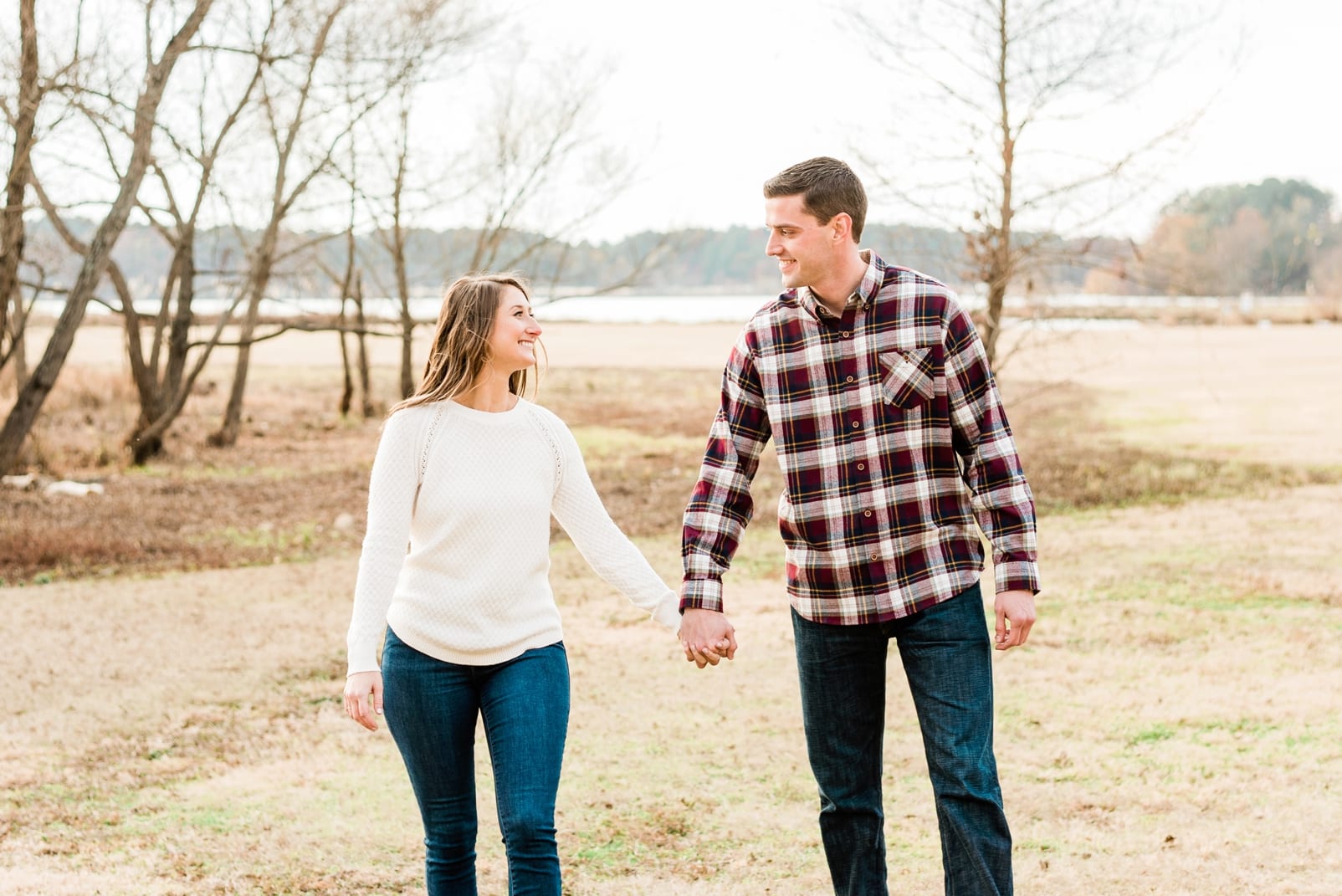 Raleigh couple holding hands and looking at each other while walking photo