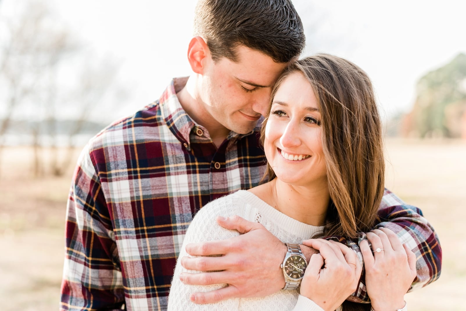 Raleigh fiance snuggled into her and has his arm wrapped around her shoulders photo