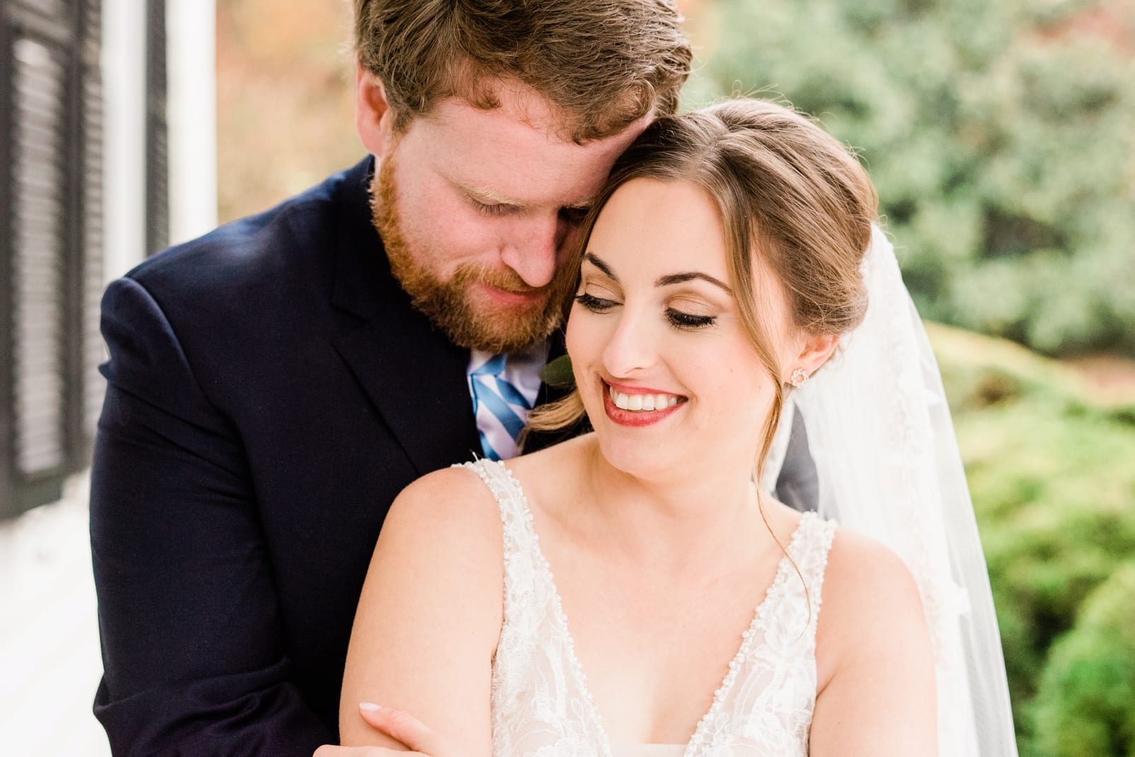 Raleigh wedding groom with his arms wrapped around his wife photo