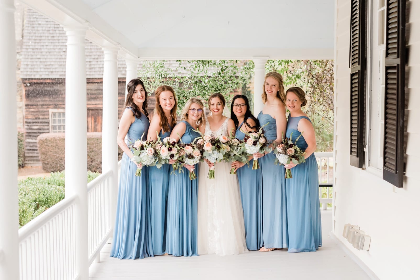 Sutherland Estate bride and bridesmaids standing together on the front porch of the estate photo