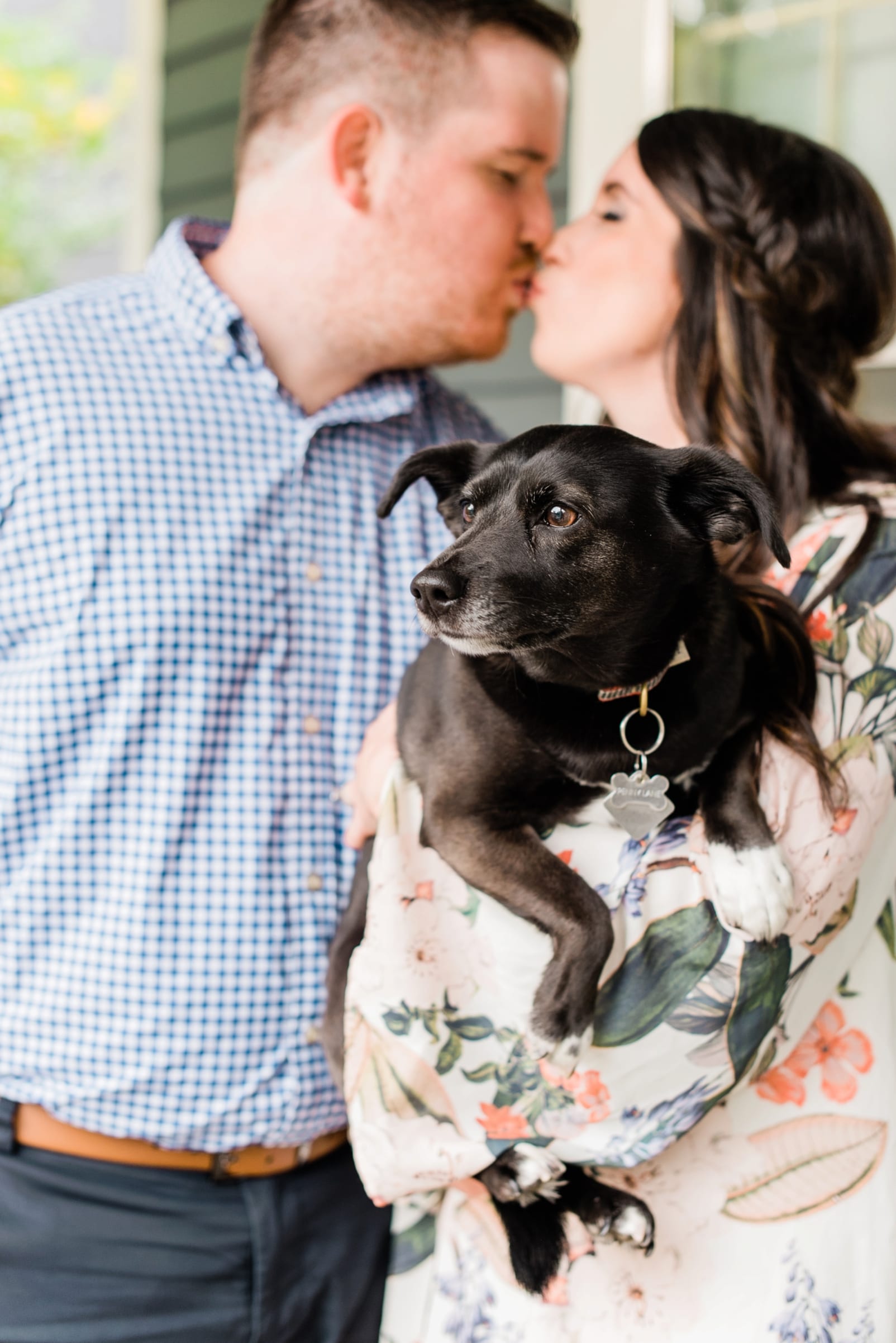 Raleigh couple with their black dog in her arms photo