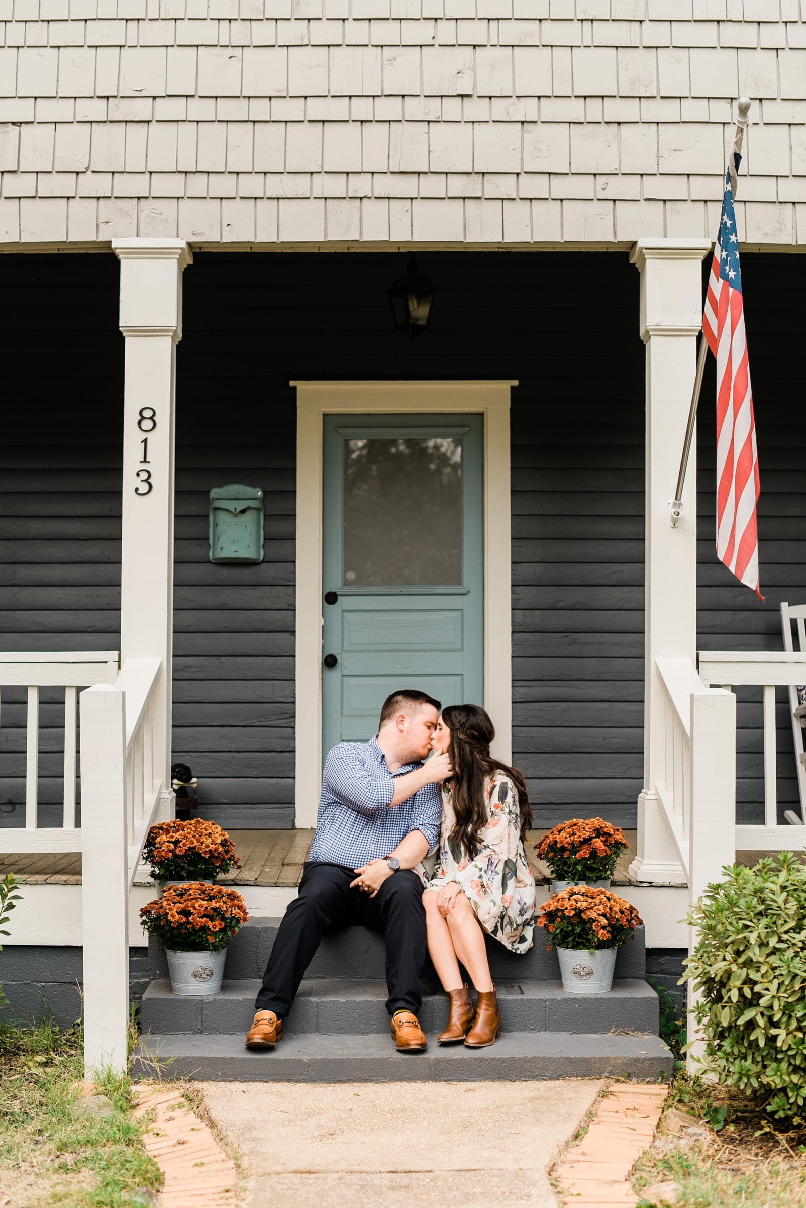 Raleigh couple kissing on their front porch during their anniversary session photo