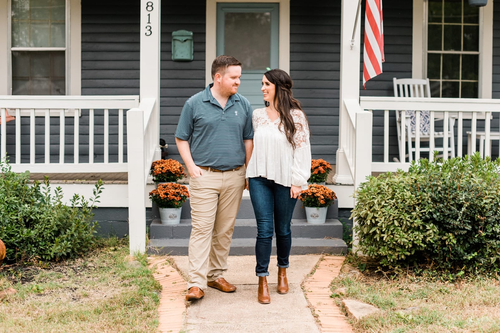 Raleigh couple walking down their front walk during their anniversary session photo