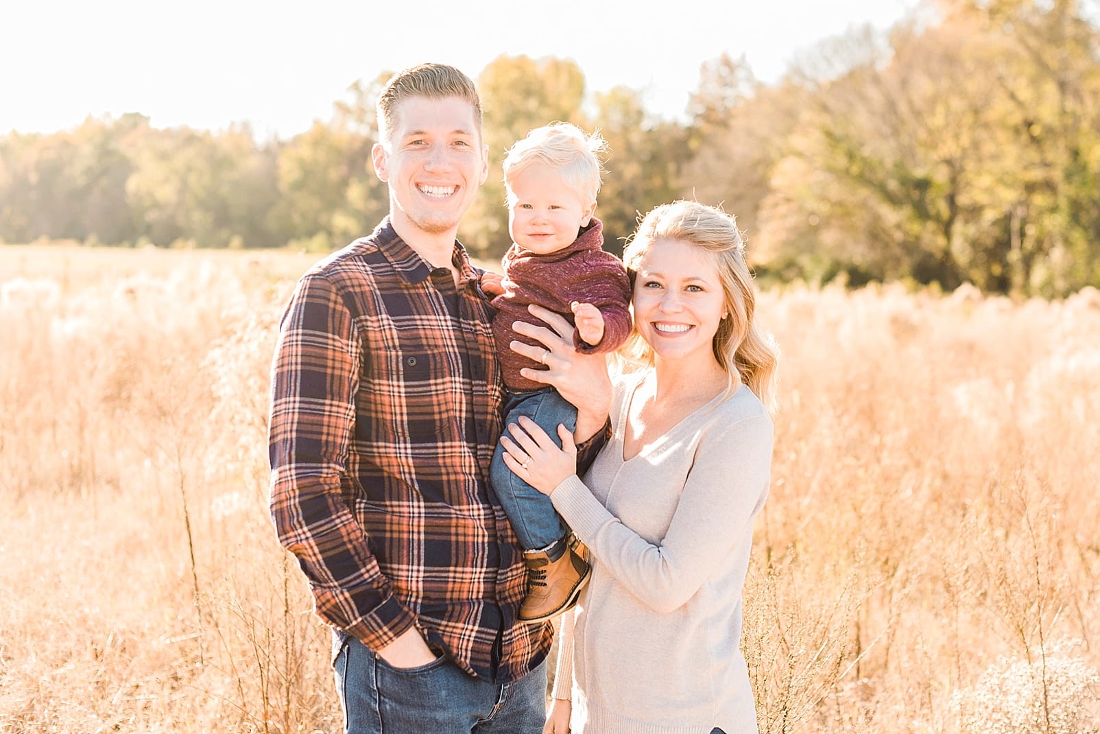 Wake Forest family of three together in a wheat field photo