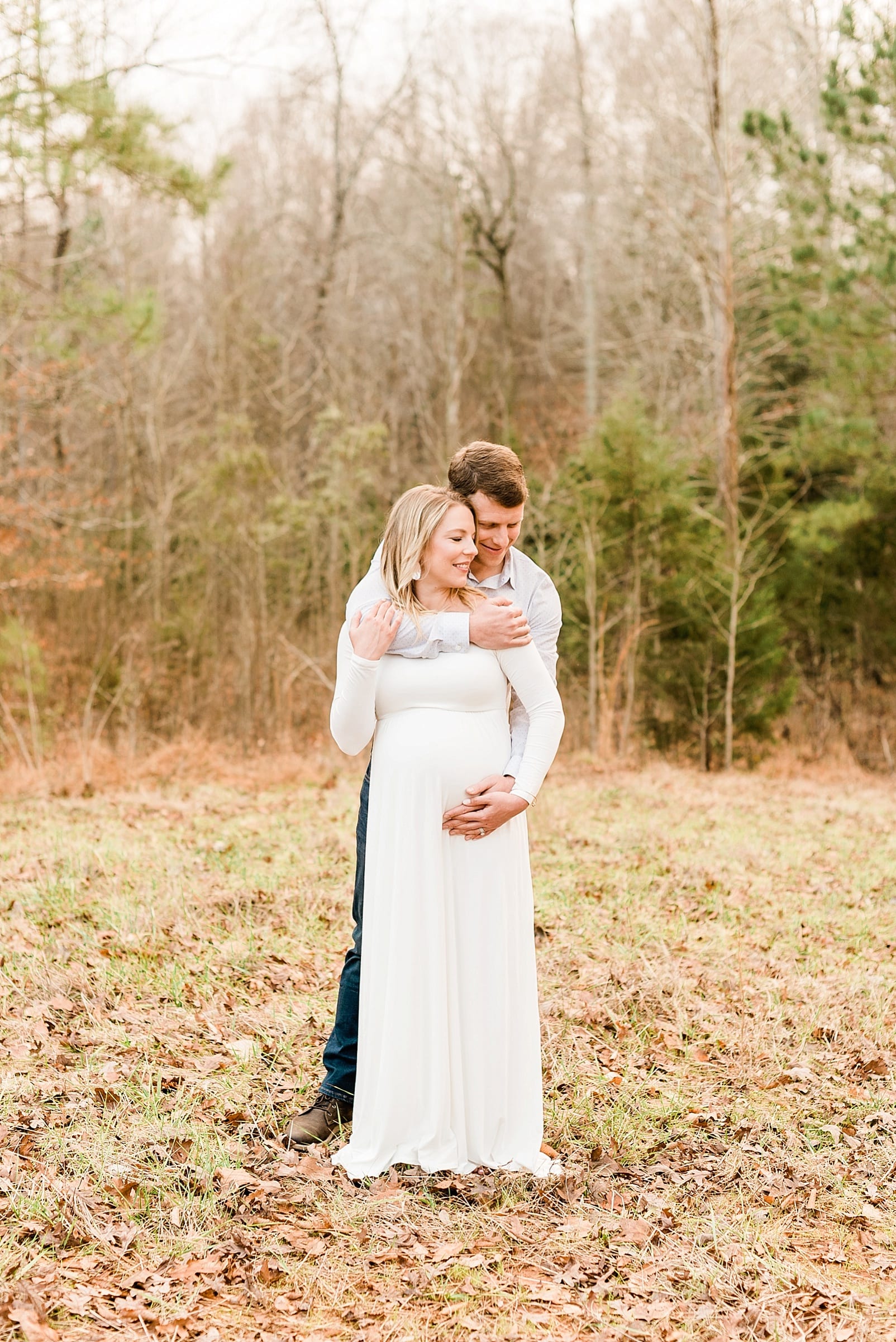 Wake Forest husband hugging his wife from behind during their Wake Forest maternity session photo