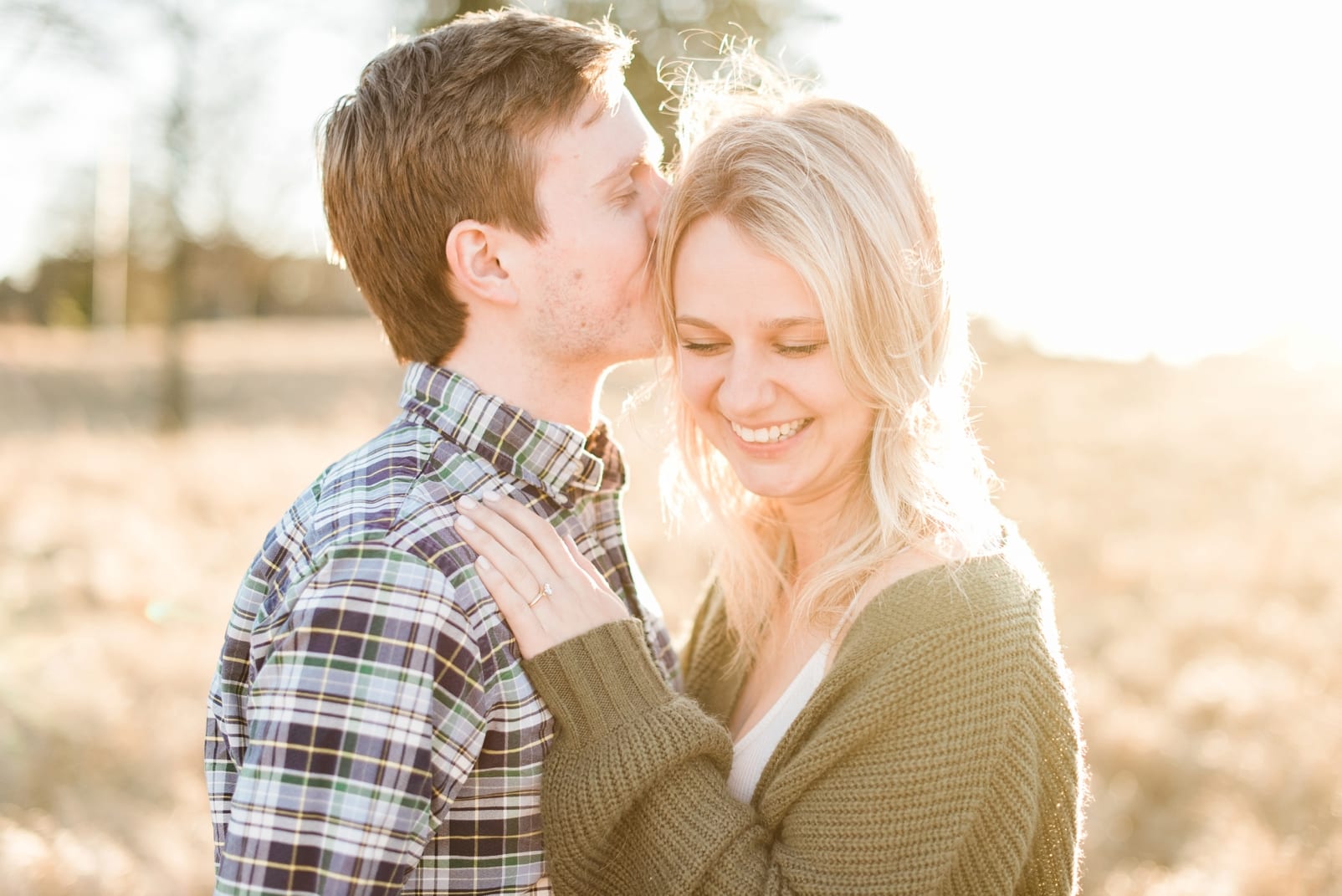 Raleigh groom kissing his bride on her hand during their engagement session photo