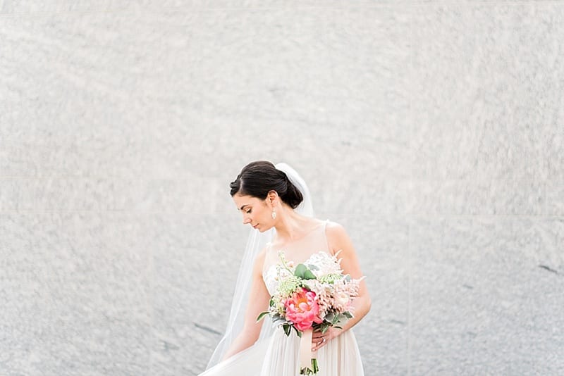 raleigh nc bride holding peony bouquet wearing bhldn photo