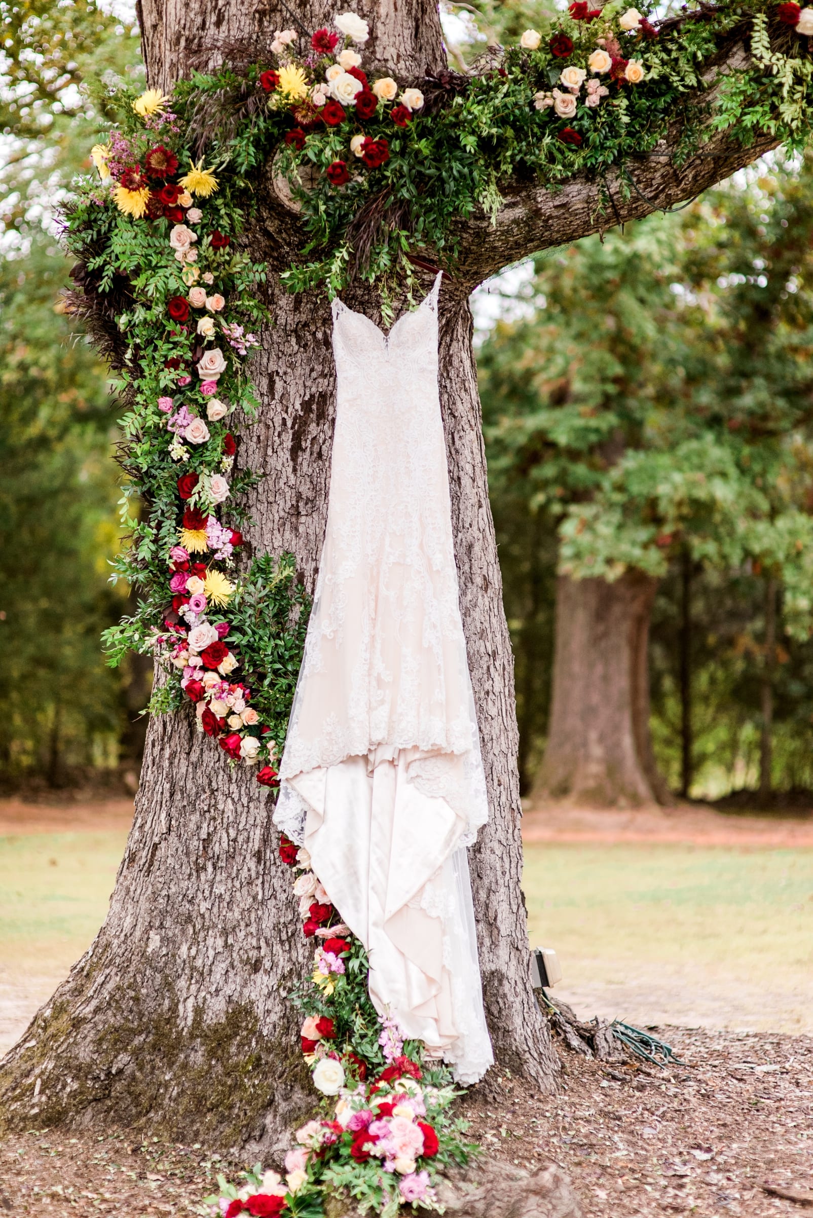 sutherland wake forest wedding photographer martina liana dress floral garland on tree photo