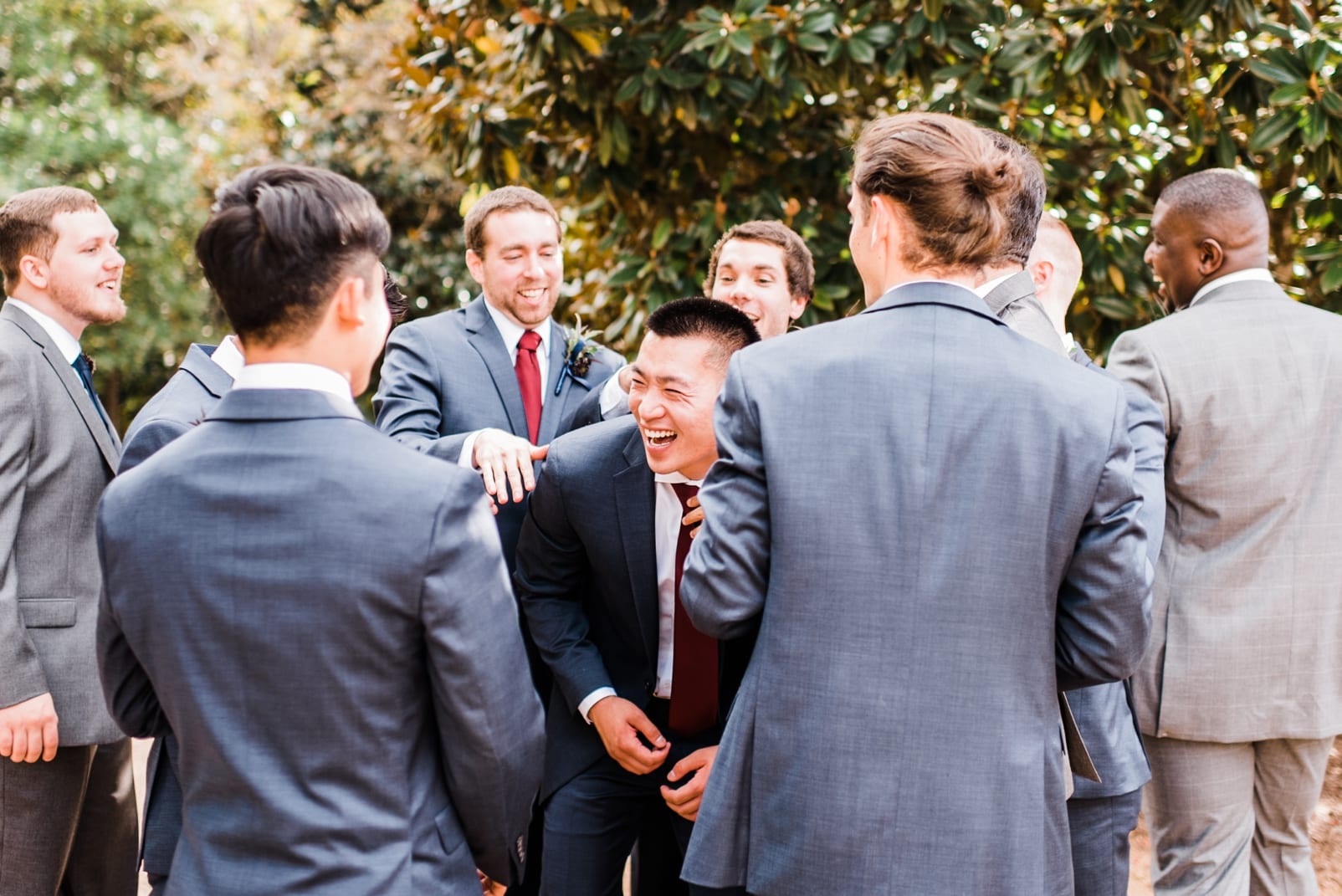 sutherland estate wedding photographer groomsmen laughing groom in navy suit photo