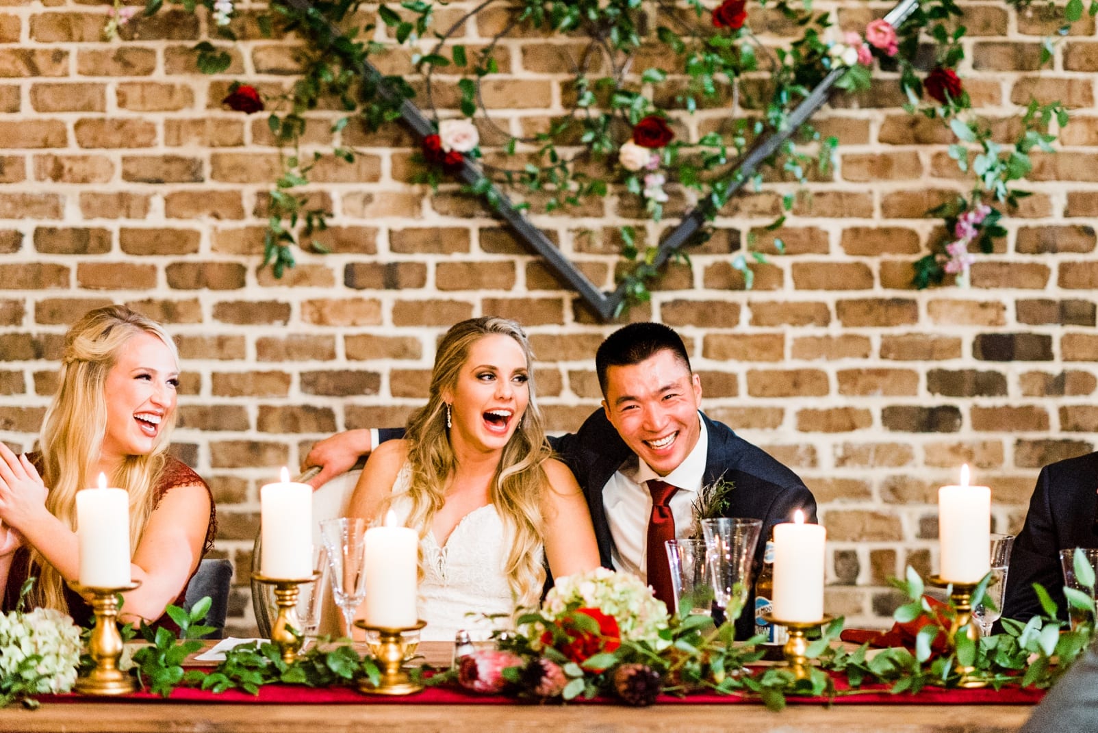 sutherland estate wedding photographer wedding reception head table inspiration bride and groom laughing photo