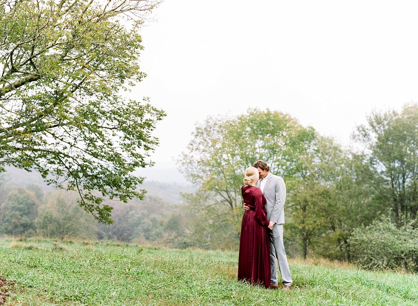 mountain engagement session couple in mountain top fog photo