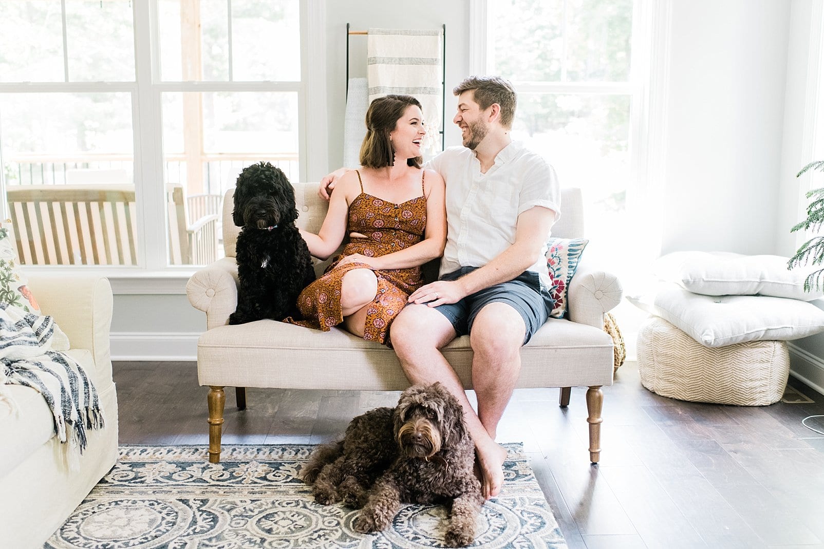 indoor lifestyle session in raleigh, nc husband and wife with their dogs photo