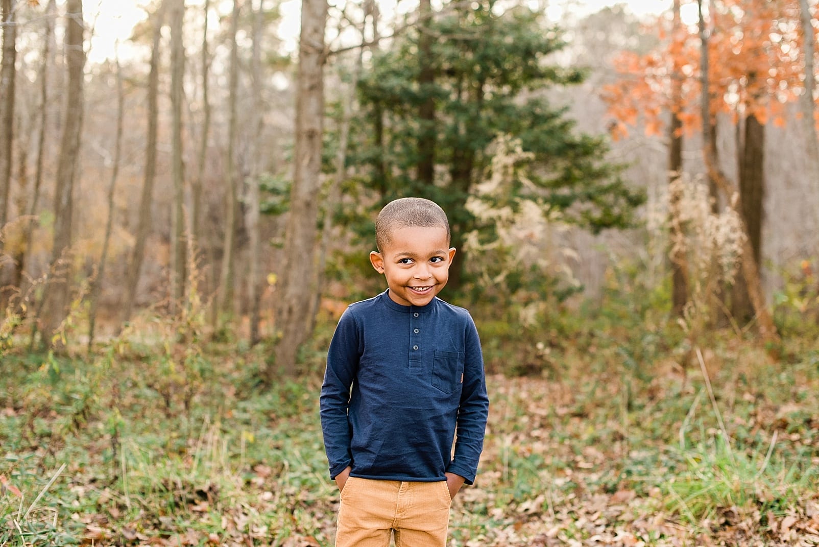 Wake Forest 6 year old boy smiling in the forest photo
