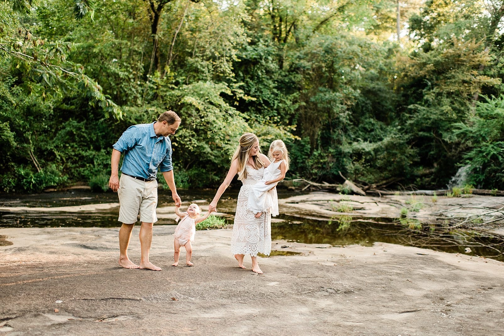 Best Wake Forest Family Photographer family walking hand in hand along a river photo