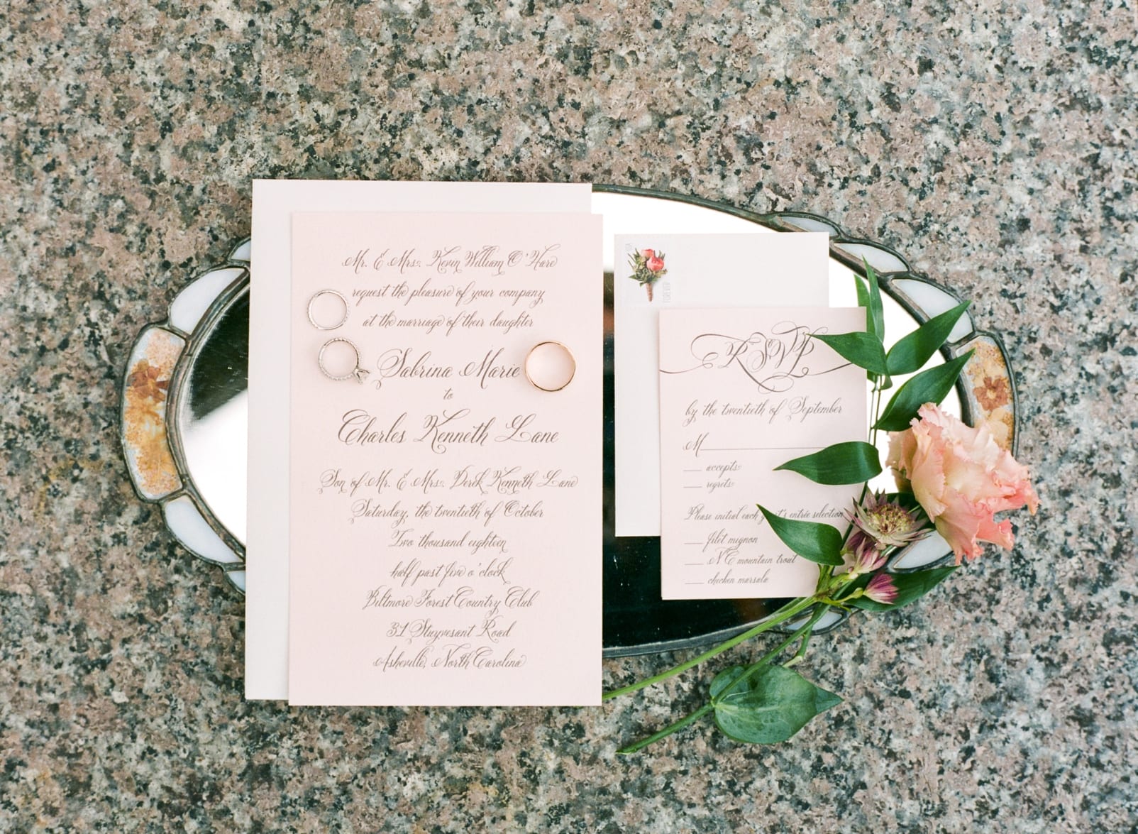 Papersource wedding invitation stationary on a silver tray styled with wedding bands and florals photo