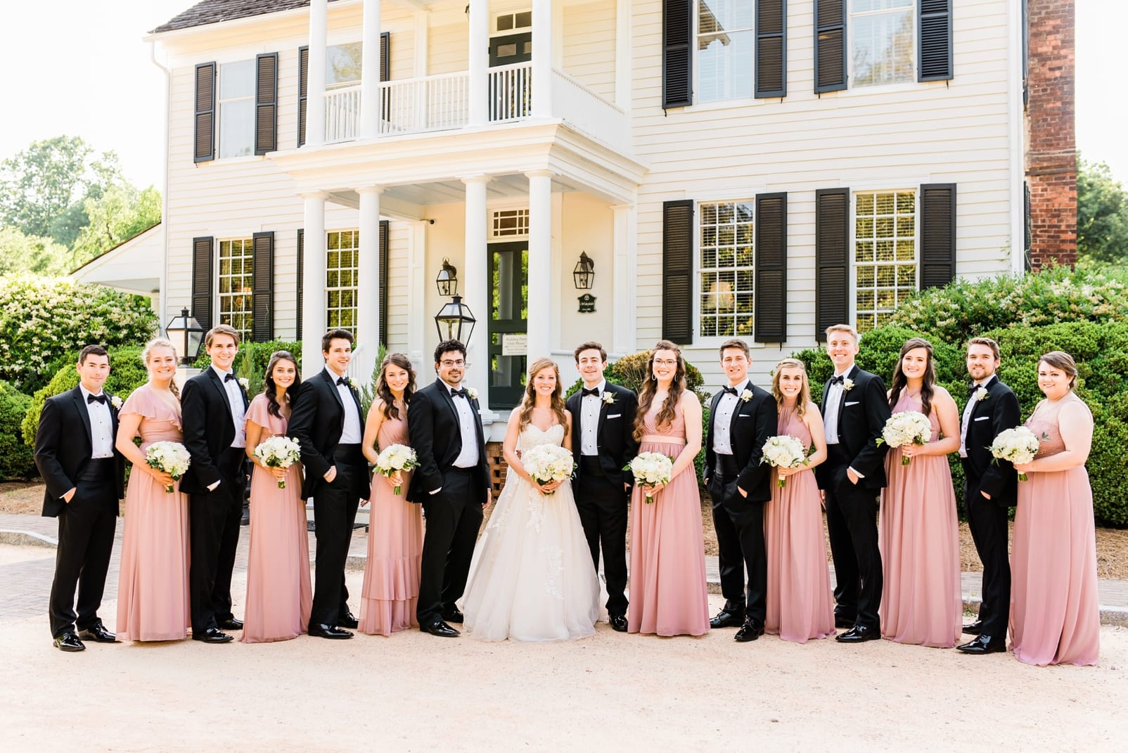 Sutherland bride and groom with wedding party standing in front of the main house photo