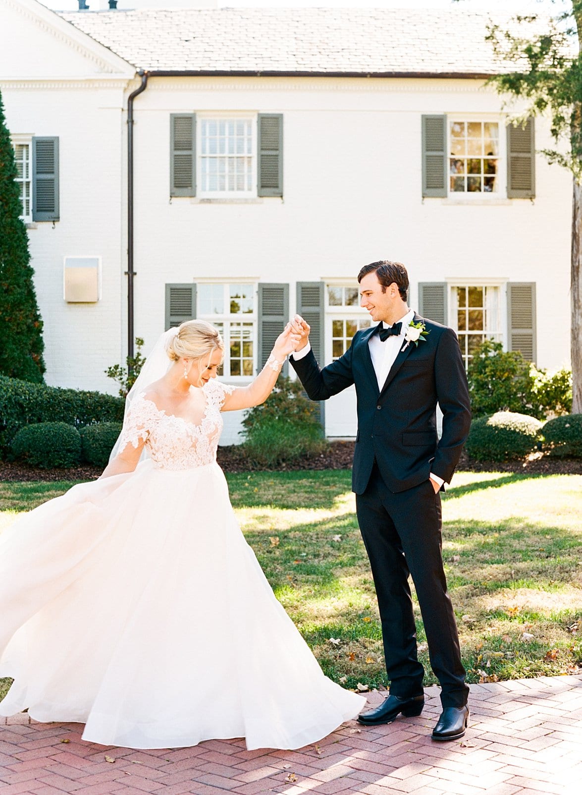 Boxwood Estate groom holding his bride's hand and twirling her photo